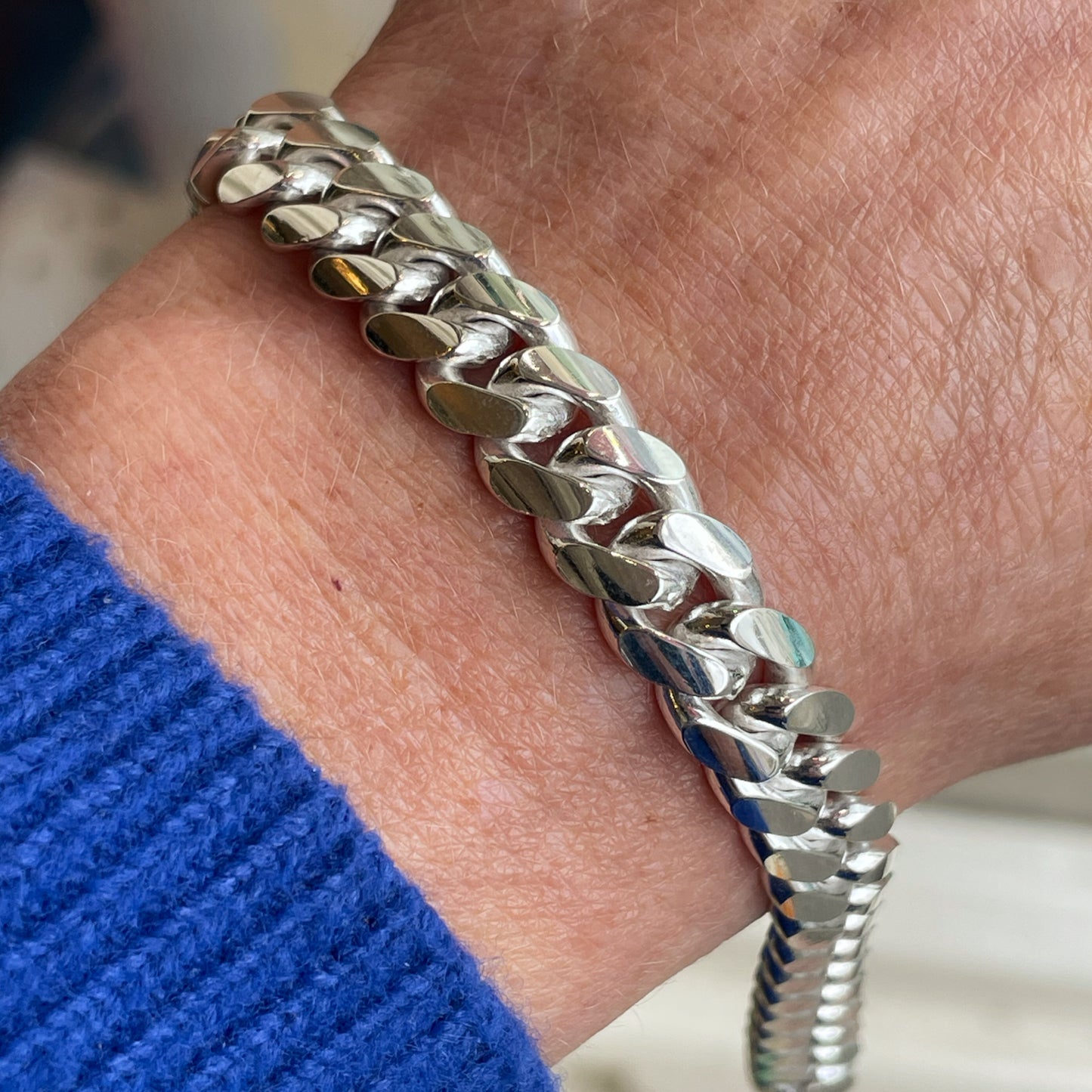 Silver chunky solid curb bracelet by Insignia with a polished finish, 21cm length, and bold, interlocked links.