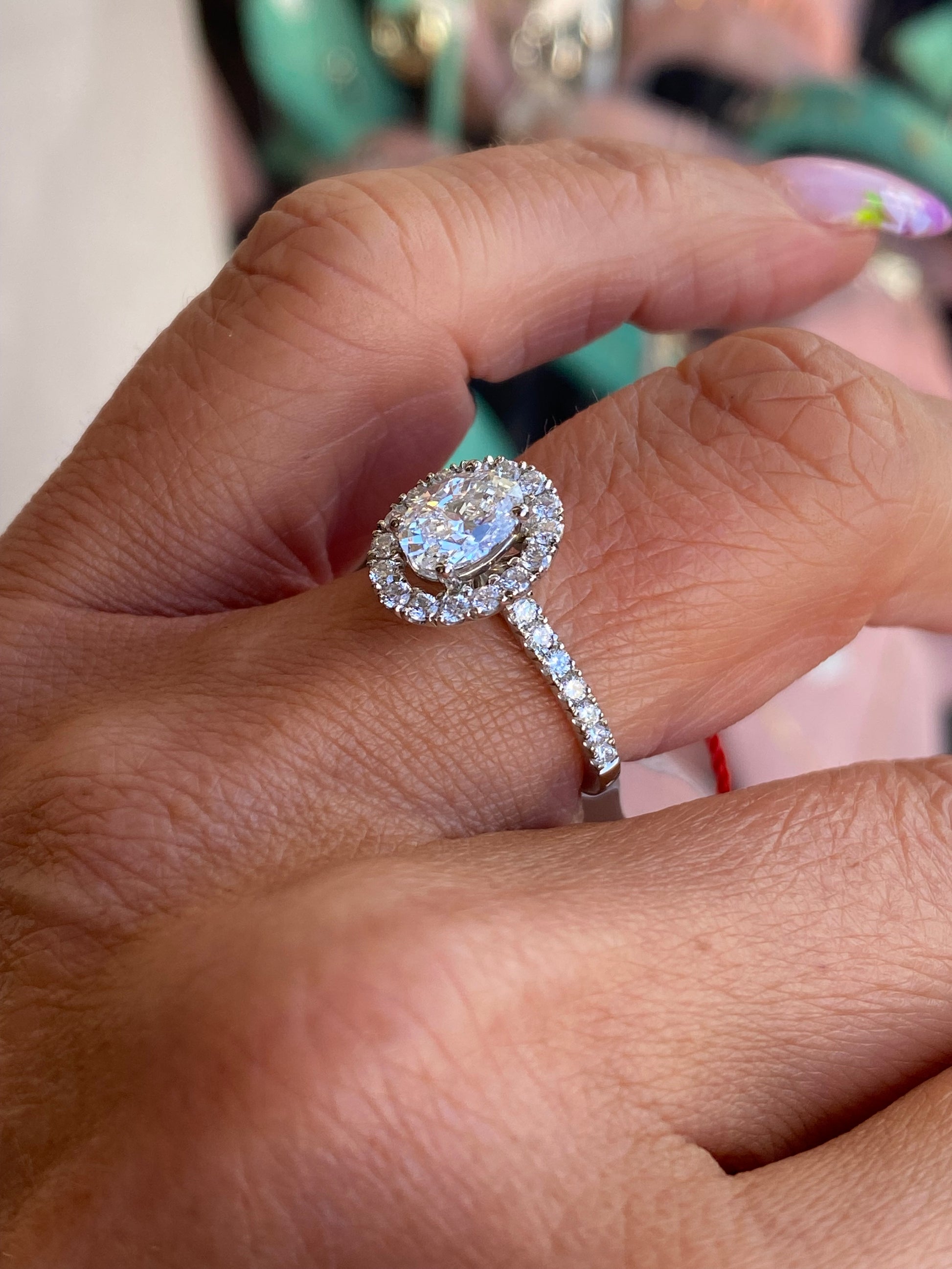 Domino platinum oval halo solitaire engagement ring with 1.00ct certificated lab diamond, featuring a sleek band and intricate halo design.