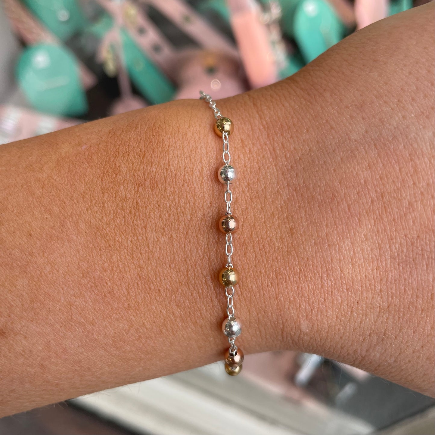 Silver Kurate rosary bracelet featuring small beads and a cross charm, designed for elegant, spiritual jewelry wear.