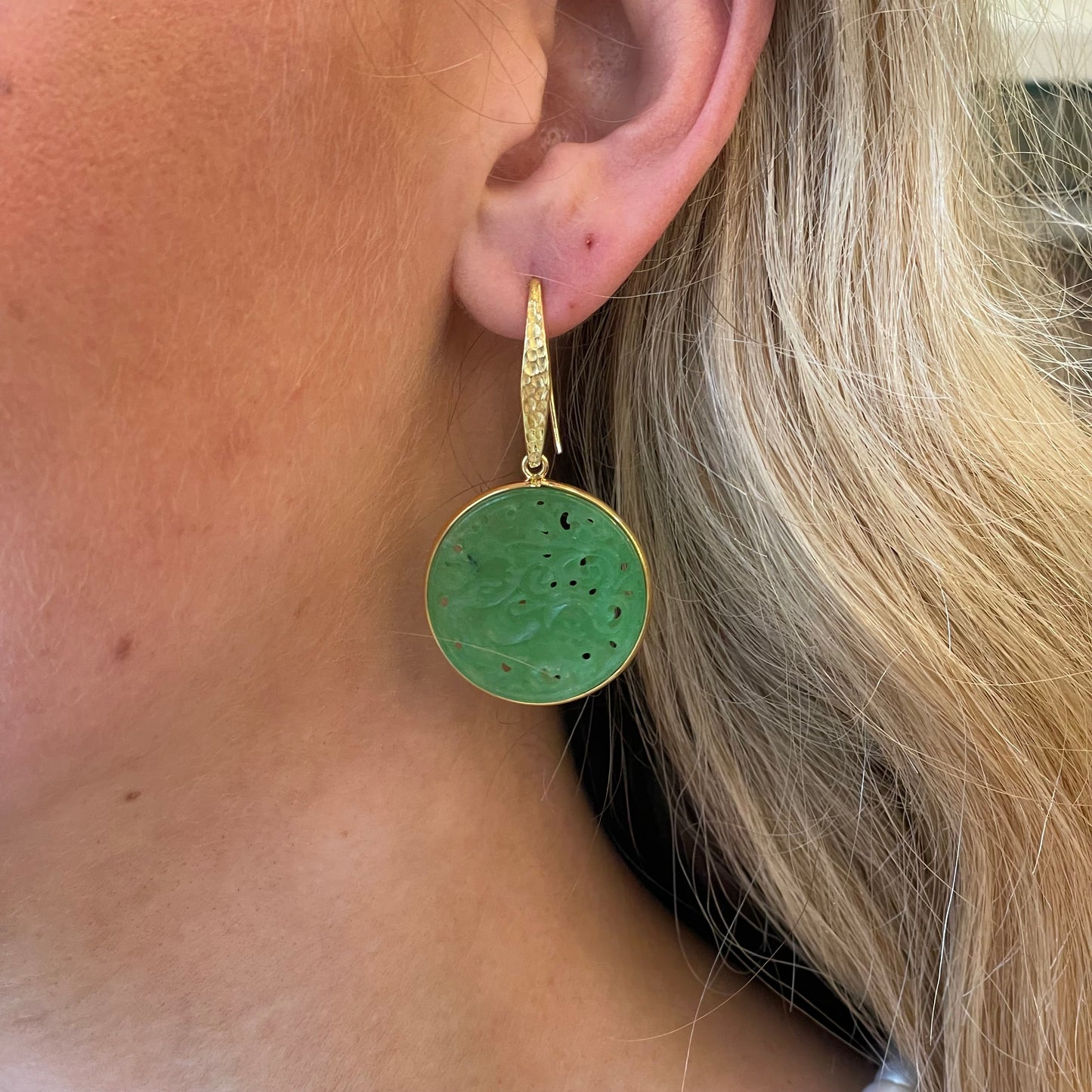 Bruno carved jade round hook drop earrings featuring intricate detailing and polished green jade stones.