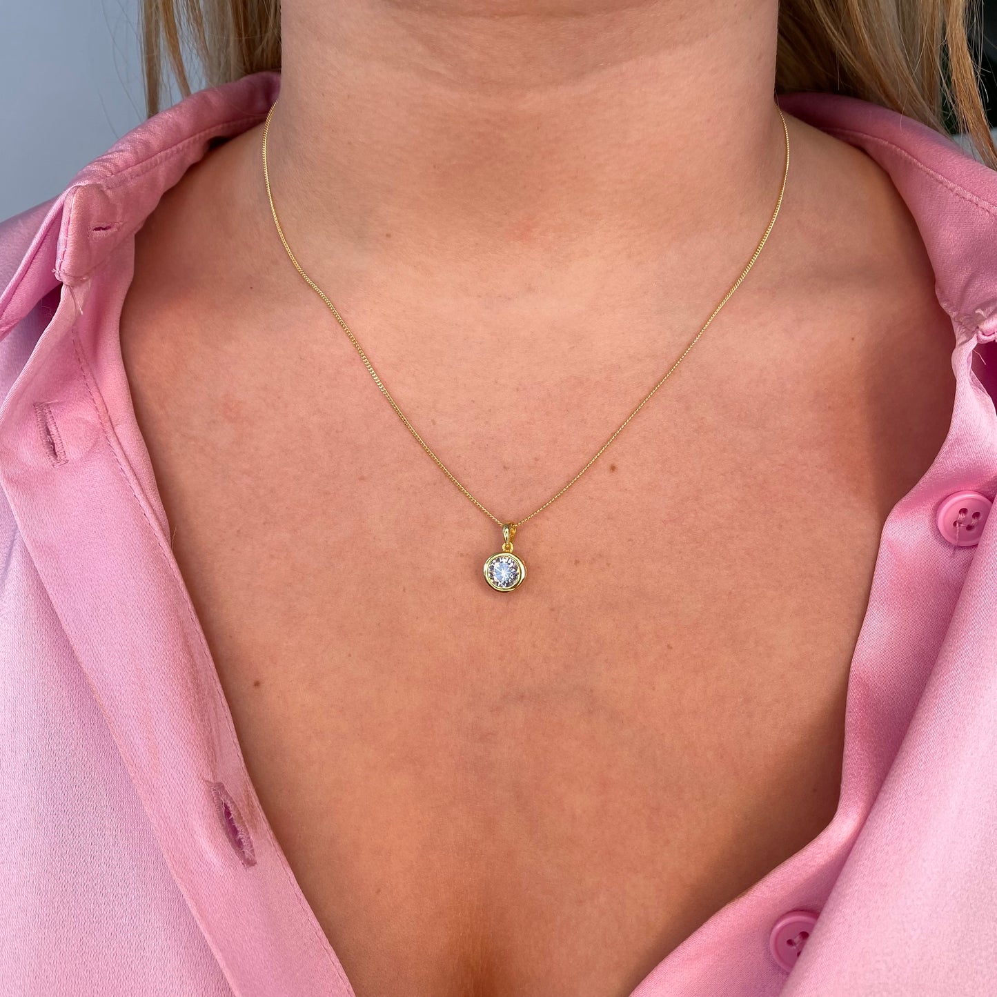 Sunshine CZ earring and necklace set by Insignia featuring round, sparkling cubic zirconia jewelry on a white background.