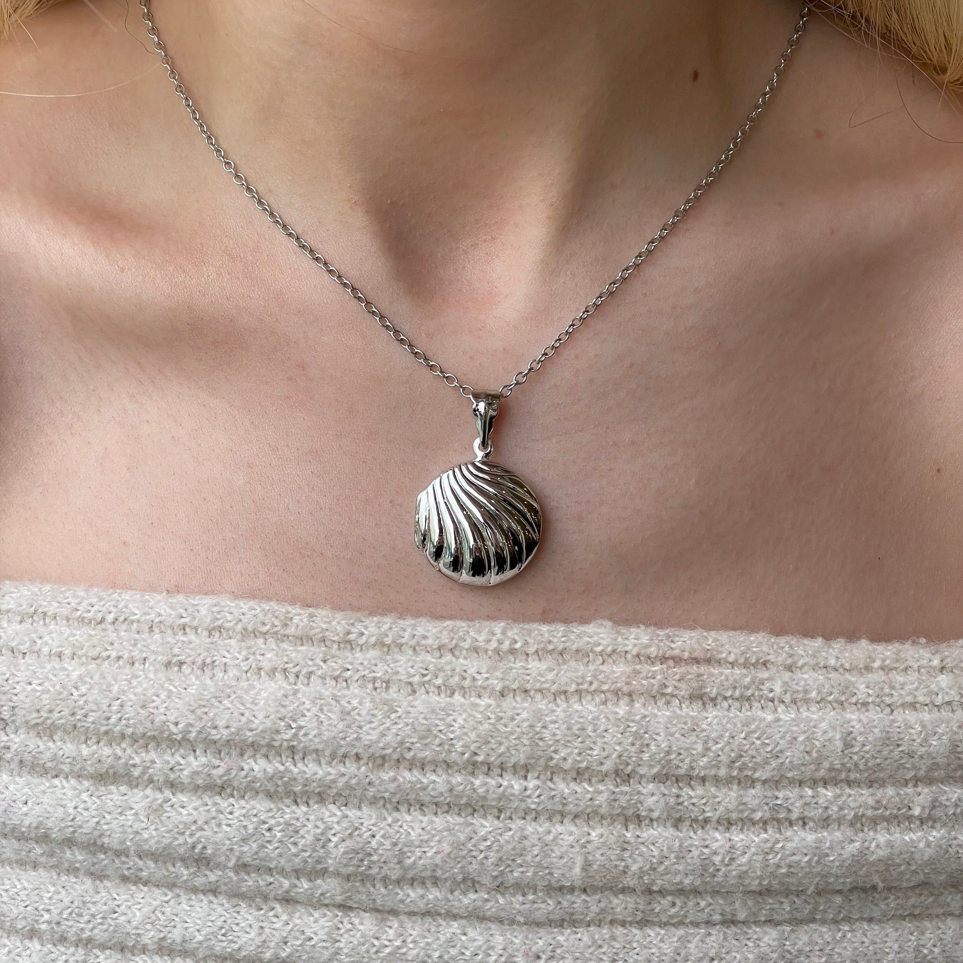 Silver round fluted locket necklace with chain, featuring a vintage-inspired design and intricate detailing.