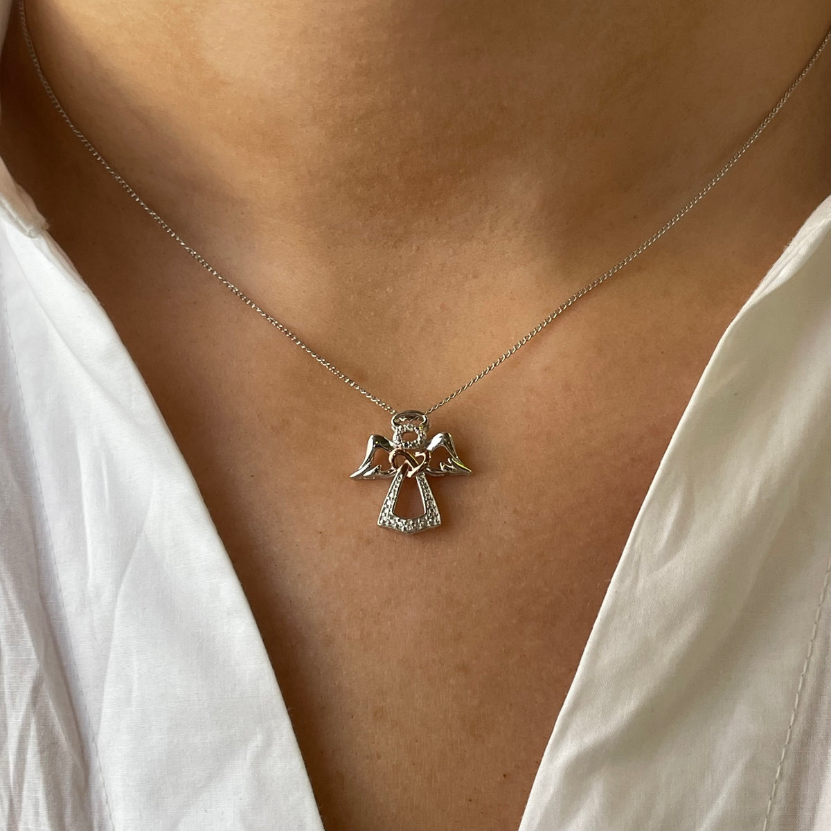 Silver Guardian Angel Pendant Necklace by Insignia, featuring a detailed angel charm on a sleek silver chain.