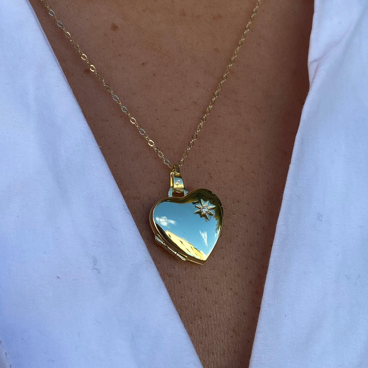 9ct gold diamond heart locket necklace by Mark Milton, featuring a detailed gold heart with embedded diamonds on a delicate chain.