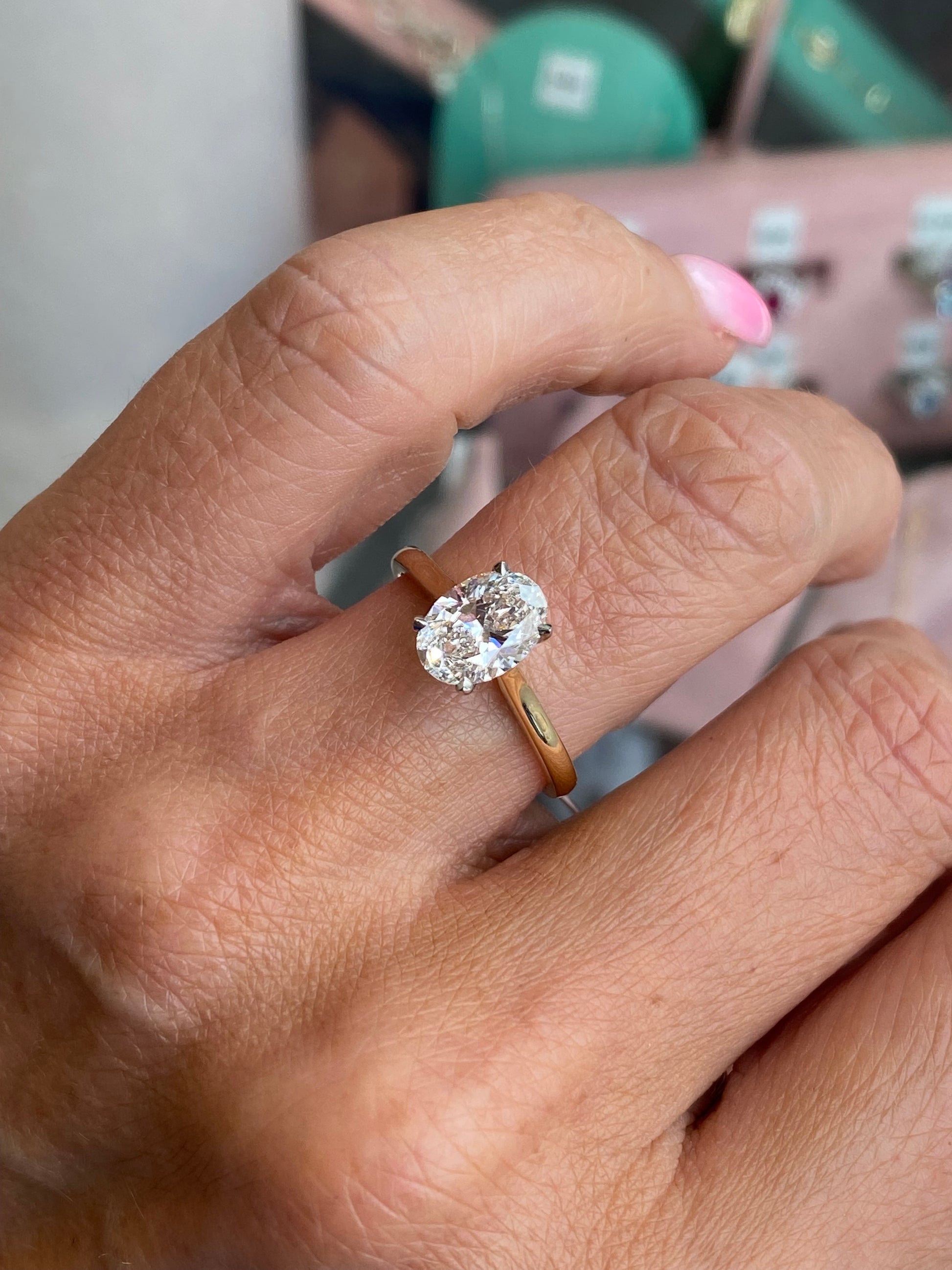 18ct gold oval solitaire engagement ring by Domino with a 1.51ct certificated lab diamond, showcasing the elegant design and shimmering stone.