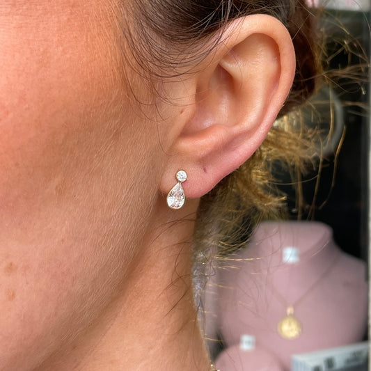 Mark Milton 9ct gold pear and round cubic zirconia stud earrings with rubover setting, showcasing elegant jewelry design.