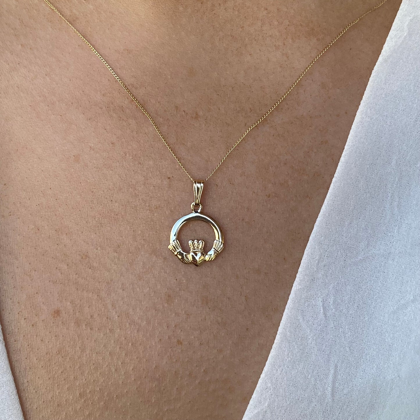 10ct gold Claddagh necklace by Facet featuring a detailed heart and crown design on a delicate chain.