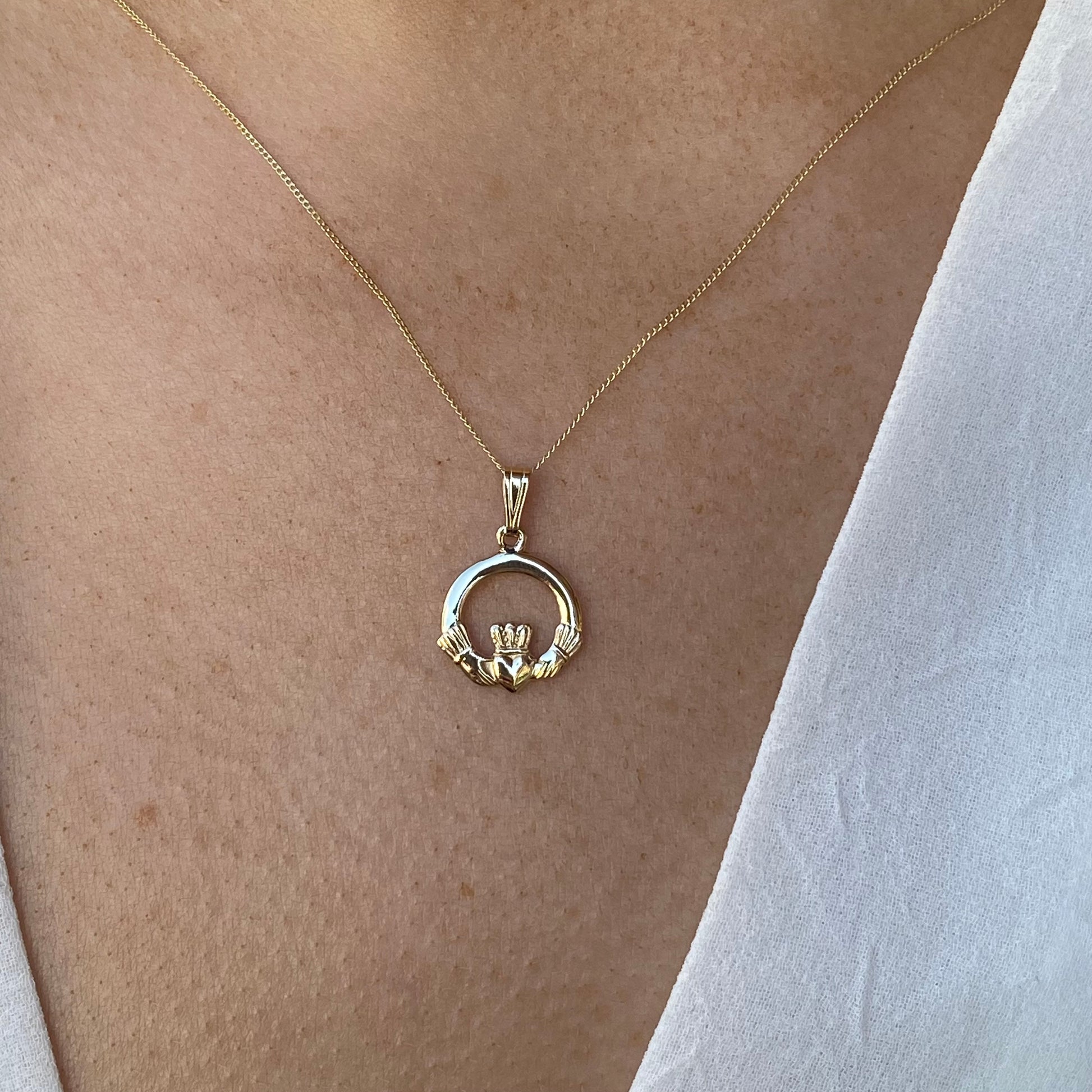 10ct gold Claddagh necklace by Facet featuring a detailed heart and crown design on a delicate chain.