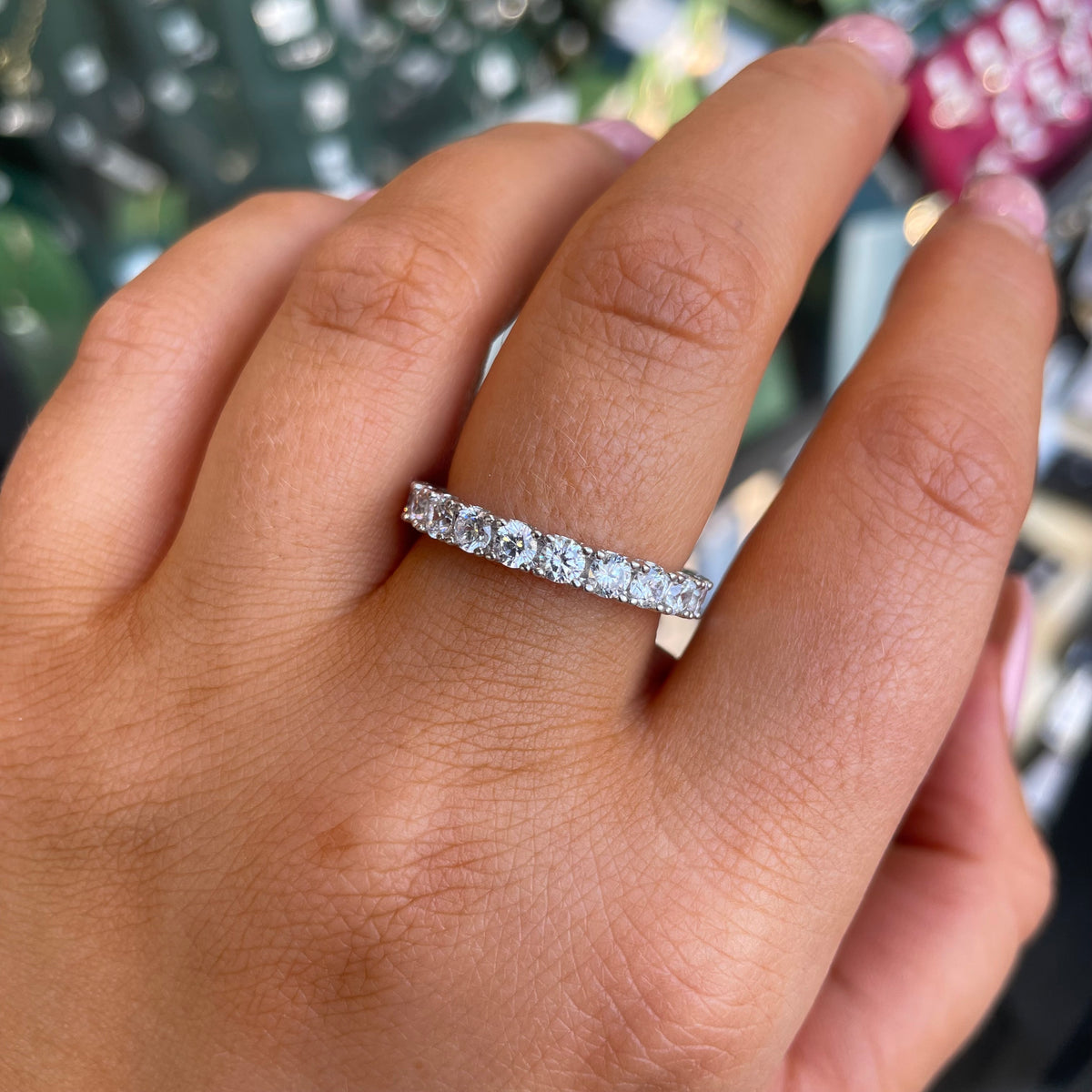 Silver CZ eternity band ring by THC featuring a continuous row of sparkling cubic zirconia gemstones.