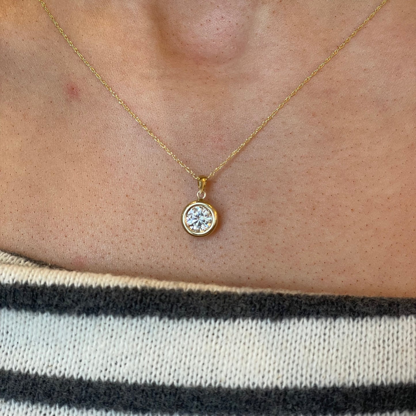 9ct gold bezel set CZ necklace with a 6mm sparkling cubic zirconia, showcasing elegant jewelry design by NJO.