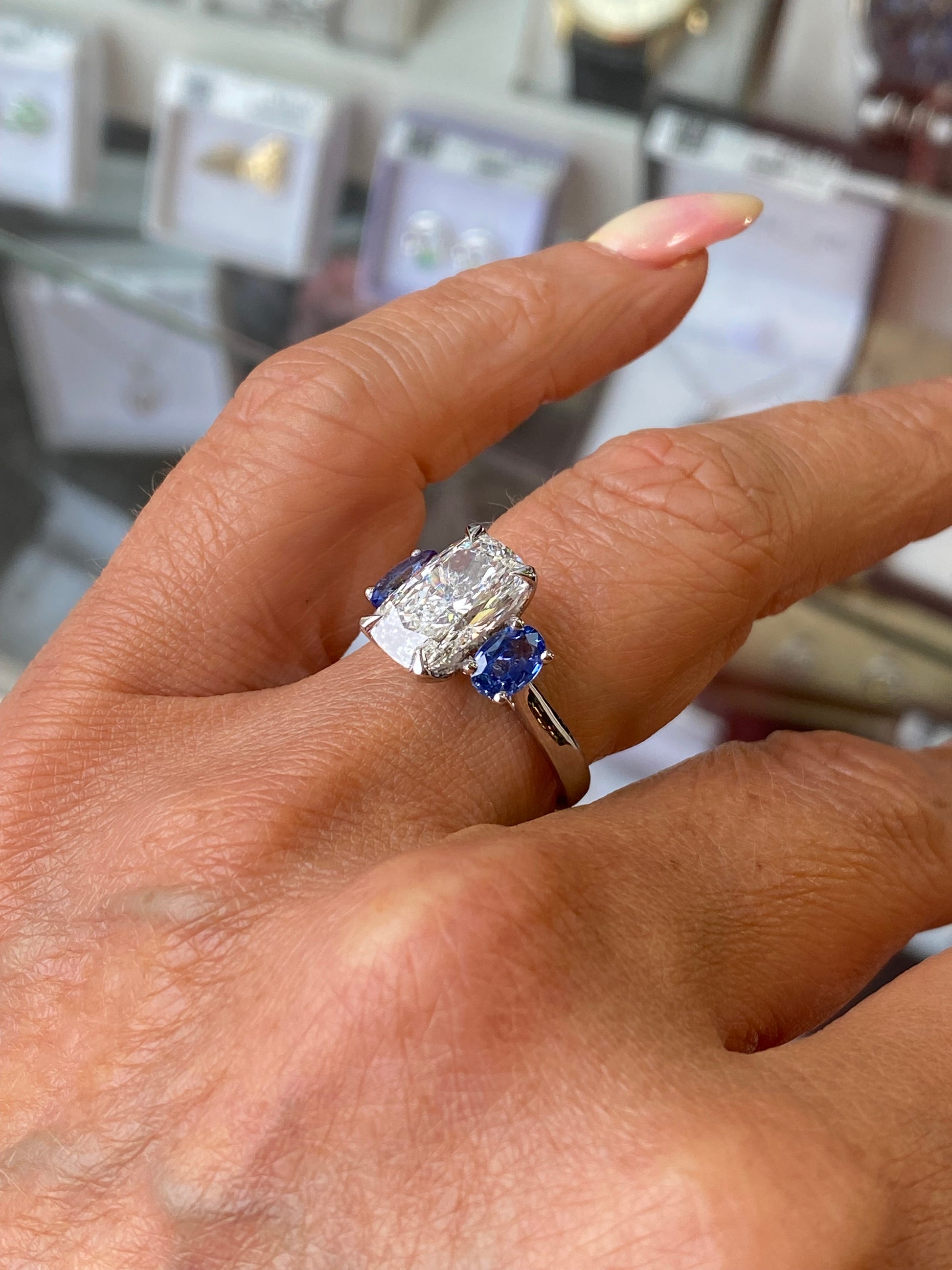 Platinum Elongated Cushion & Sapphire Trilogy Ring - John Ross Jewellers