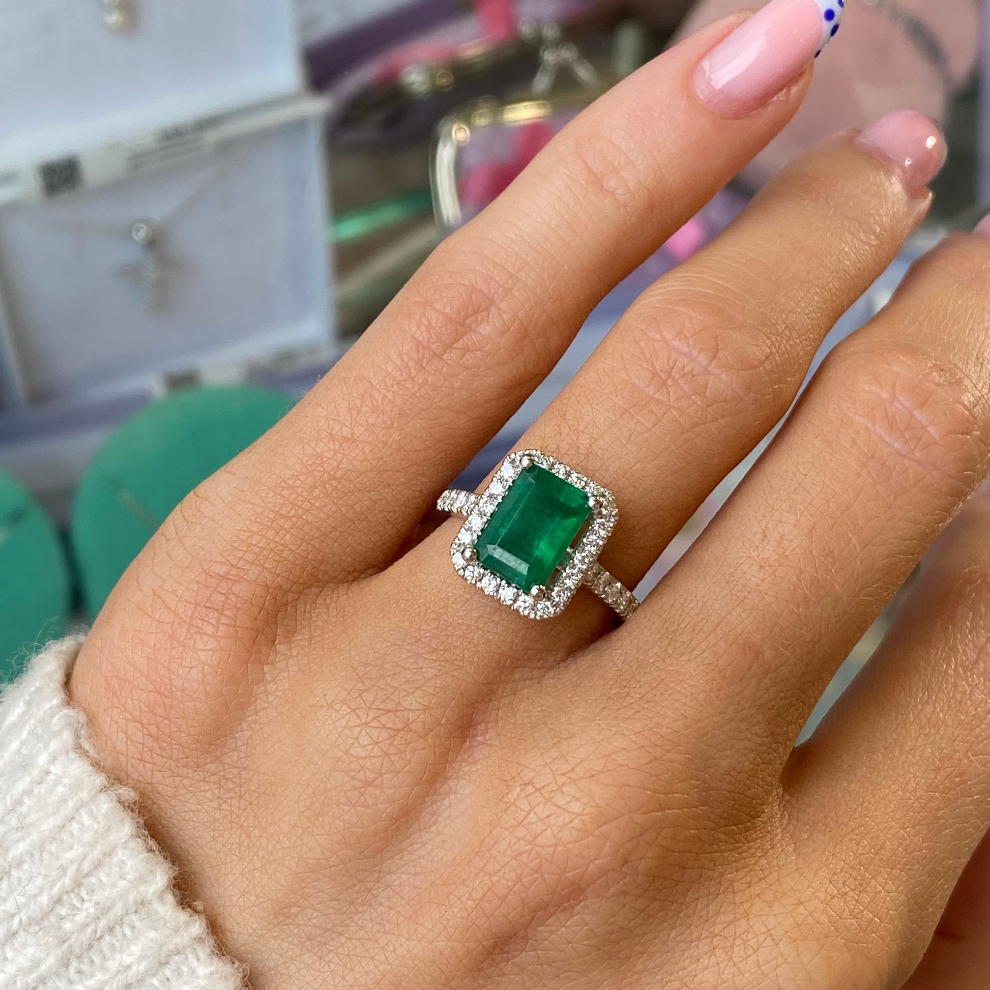 Herbert platinum emerald and diamond octagon ring showcasing a central emerald gemstone surrounded by sparkling diamonds.