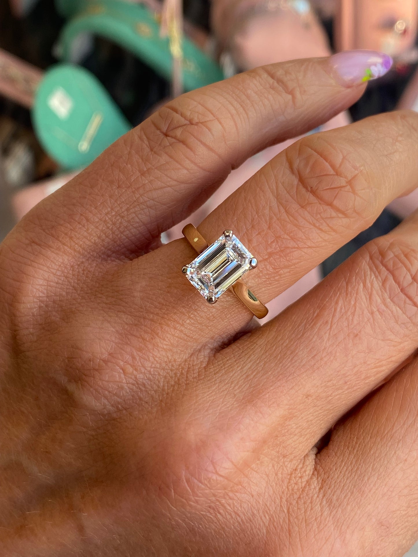 18ct gold emerald cut solitaire engagement ring with a 2.58ct certified lab diamond, featuring a sleek band and elegant design.