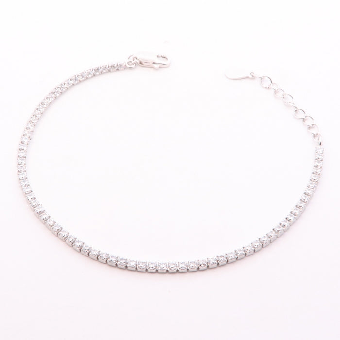 Silver 2mm CZ tennis bracelet by Comero with adjustable 16.5+3cm length, featuring sparkling cubic zirconia stones.