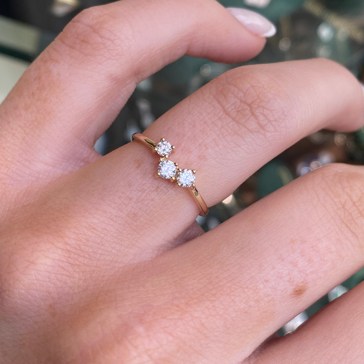 9ct gold CZ trilogy wishbone ring showing a delicate gold band with three sparkling cubic zirconia stones set in a wishbone design.
