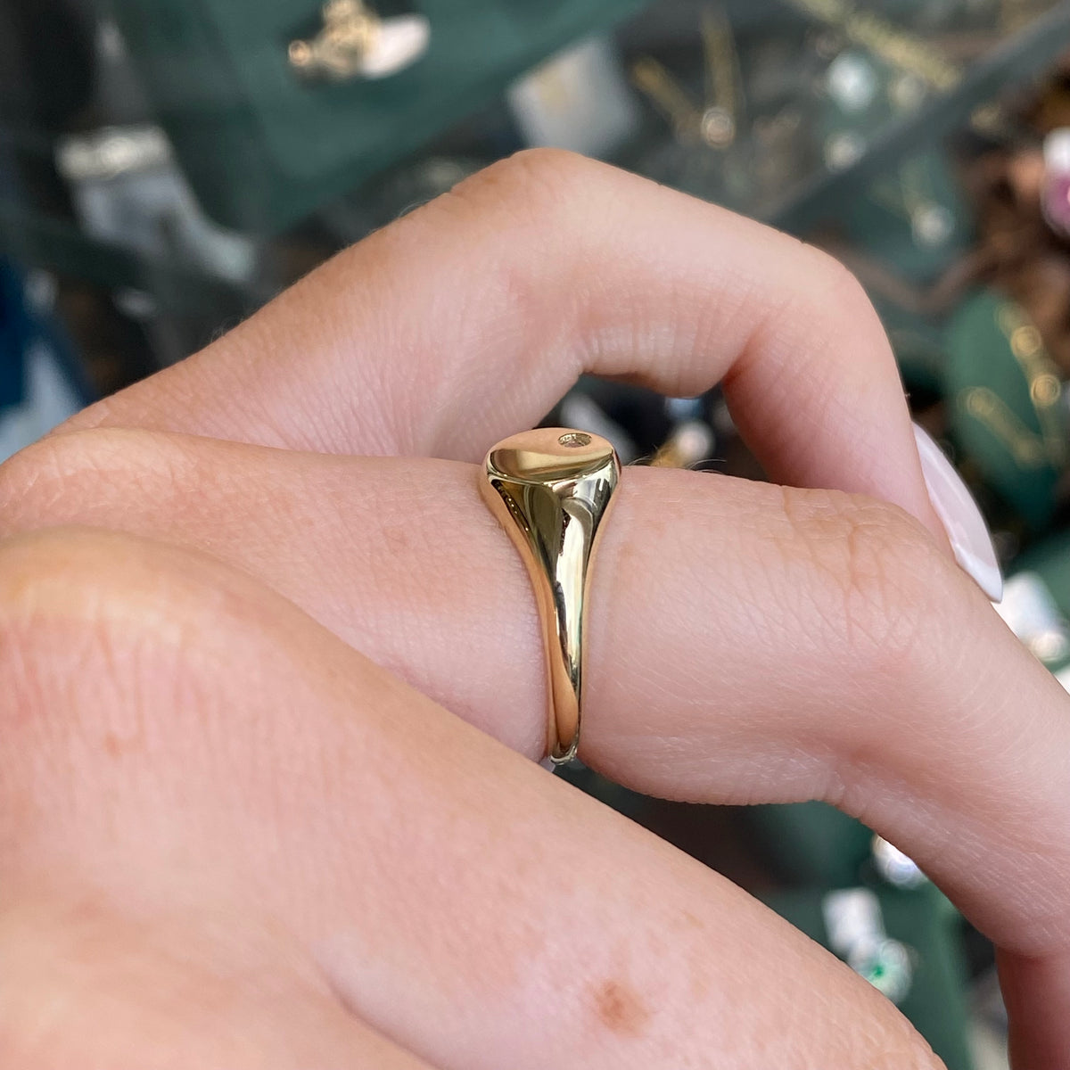 NJO 9ct gold round cubic zirconia signet ring with polished finish and engraved band, displayed on a neutral background