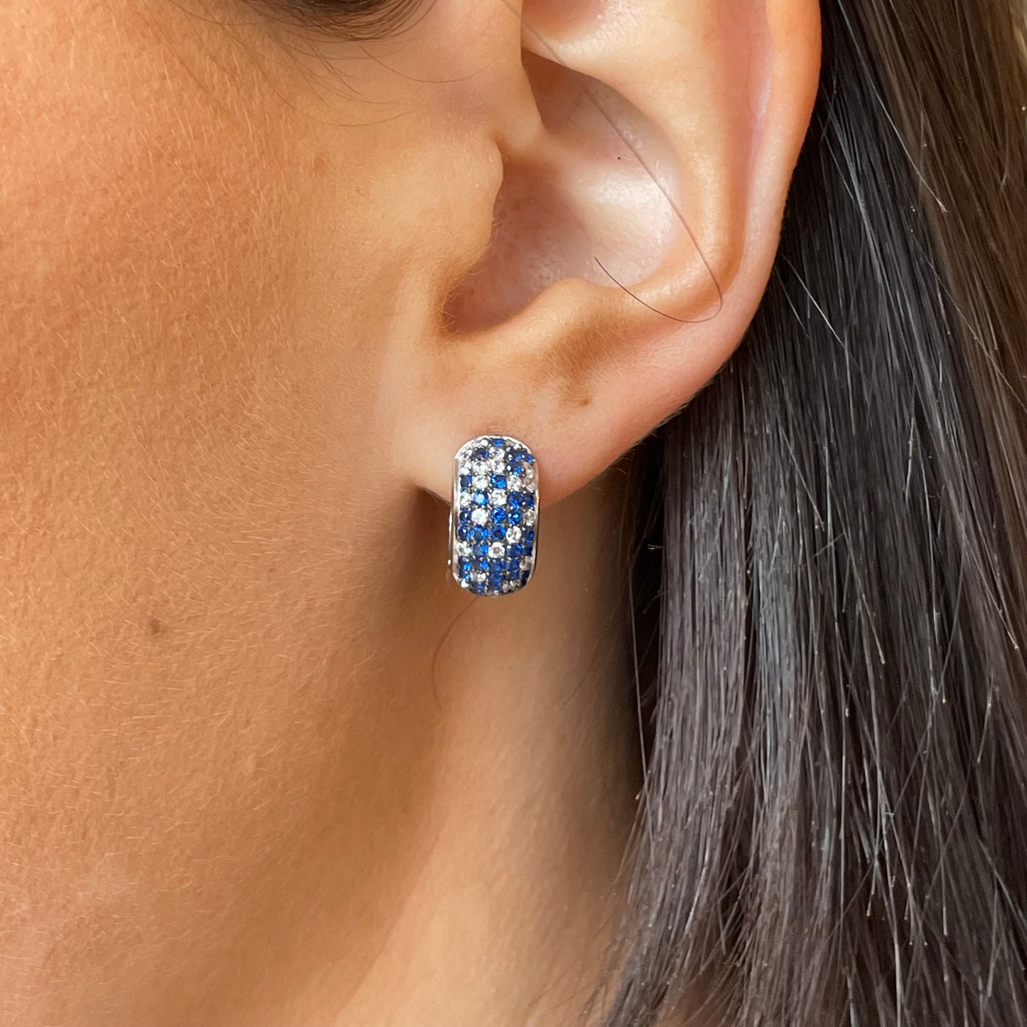 Silver blue ombre huggie hoop earrings by Comero, featuring a sleek, small hoop design with a gradient blue and silver finish.
