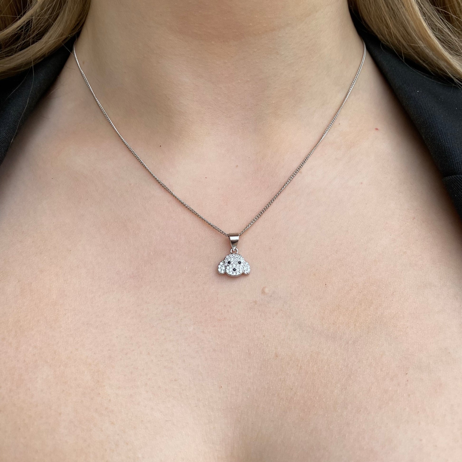 Silver CZ puppy necklace by Insignia featuring a cute puppy pendant with sparkling cubic zirconia stones.