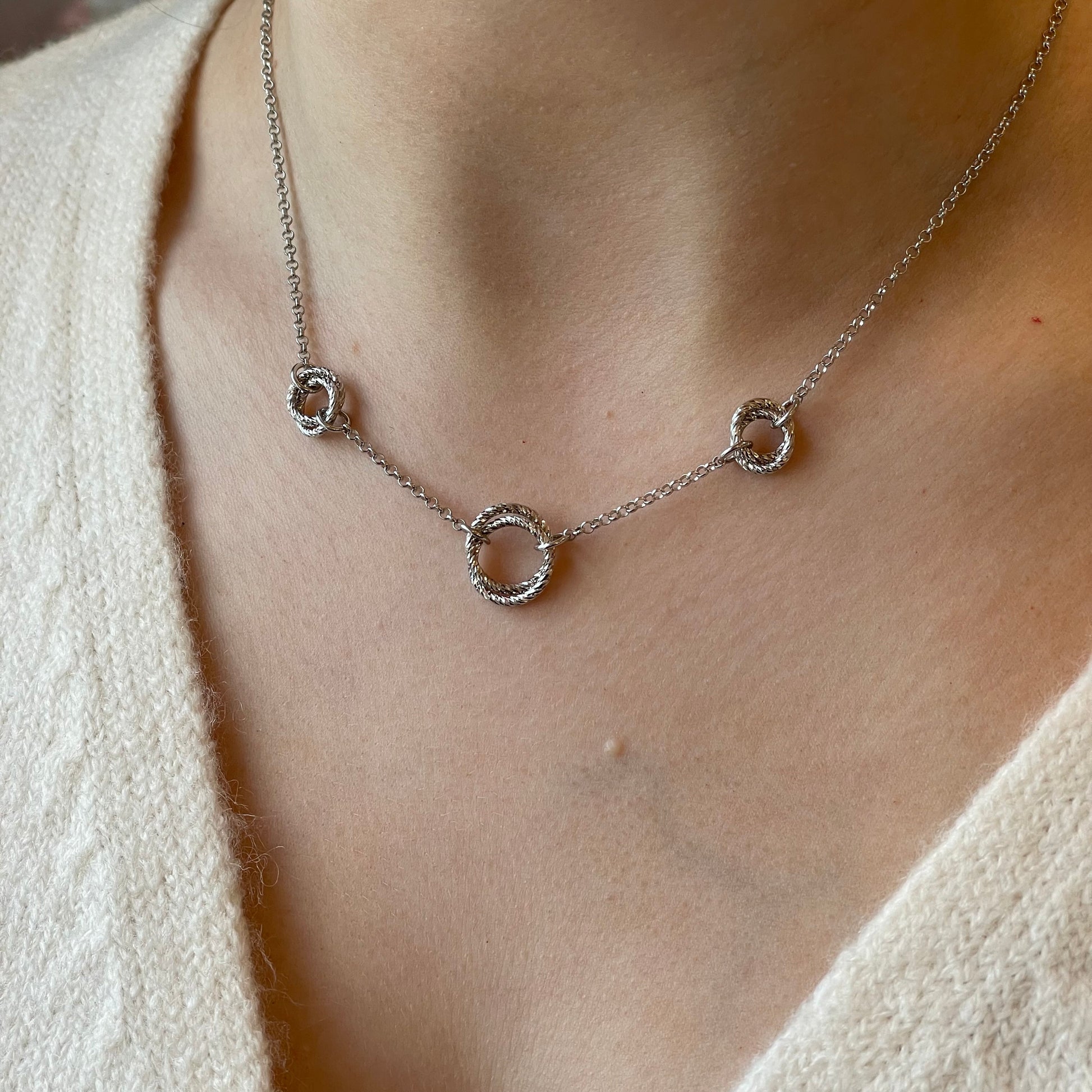 Silver Pretty Trilogy Necklace by Fraboso featuring three interconnected silver pendant circles on a delicate chain