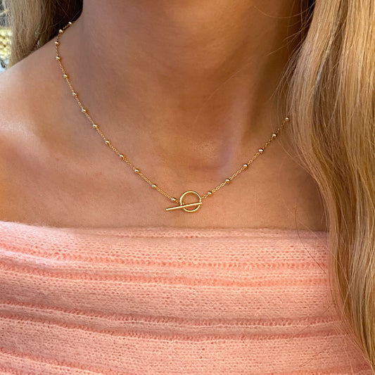 Sunshine Beaded Station T-Bar Necklace by Comero featuring gold-tone beads on a delicate chain.