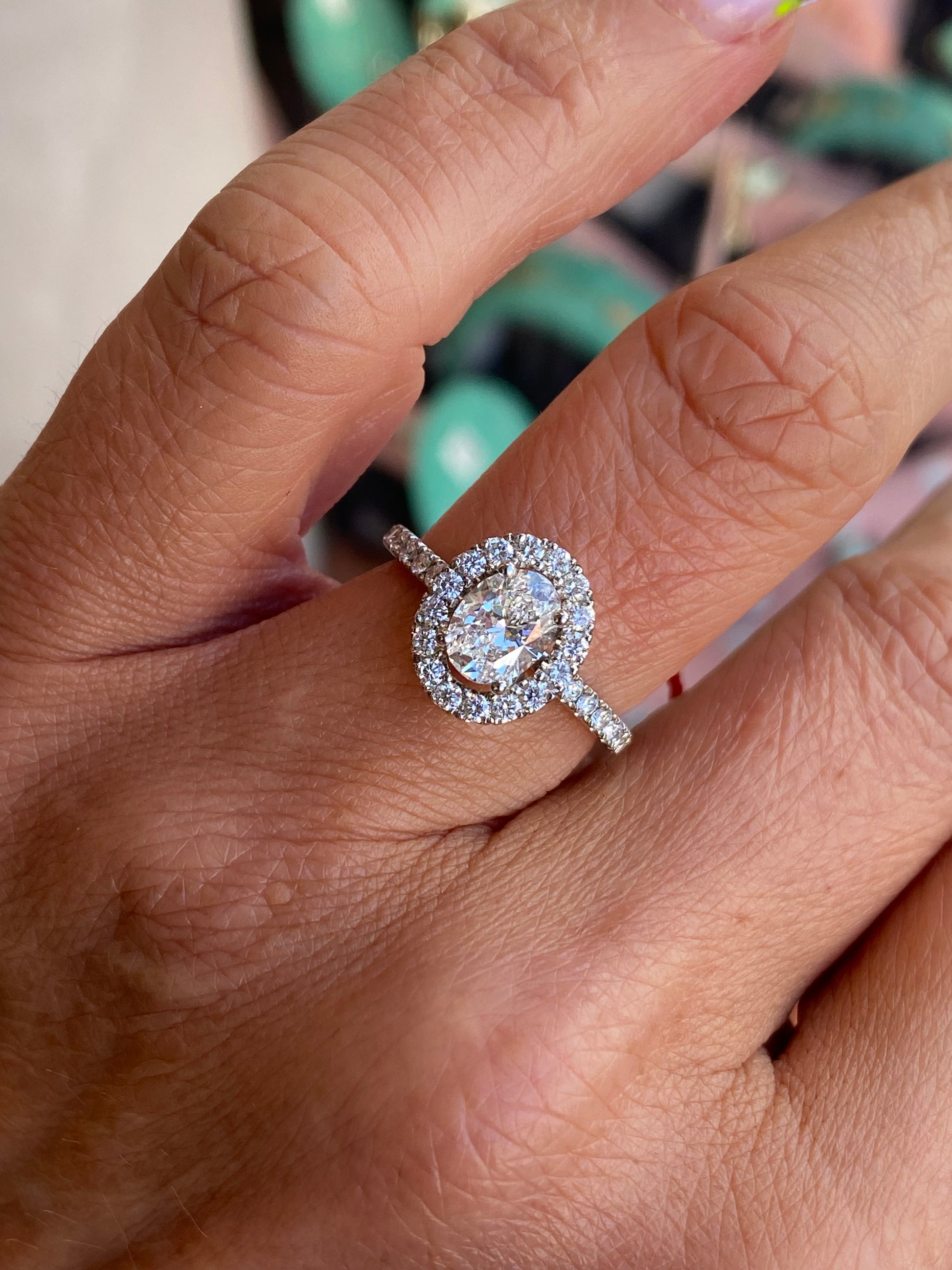 Domino platinum oval halo solitaire engagement ring with a 1.00ct certified lab diamond, featuring a sleek band and elegant design.