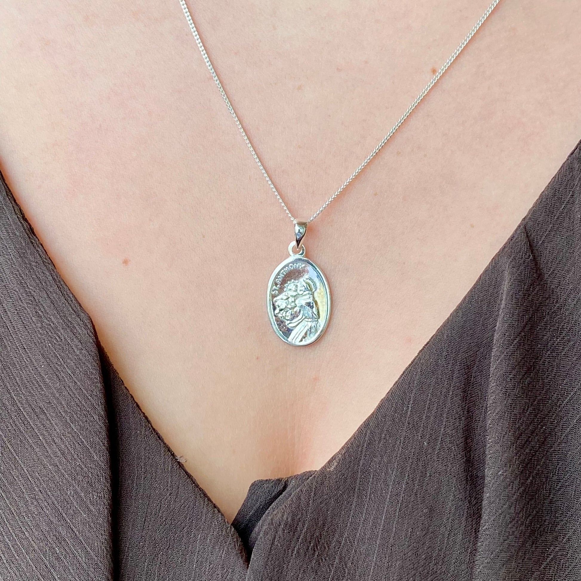 Silver St. Anthony medal on a chain necklace by Clandela, featuring a detailed religious pendant for protection and faith.