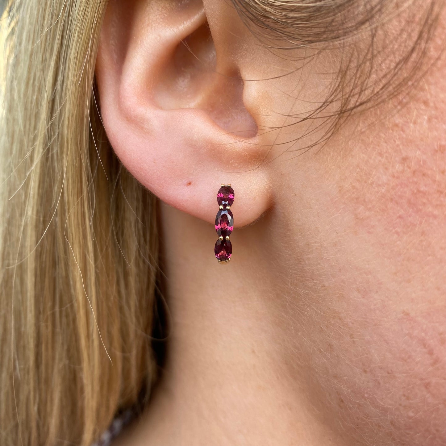 9ct gold garnet huggie hoop earrings by Mark Milton, 15mm size, featuring red garnet gemstones in a stylish hoop earring design.