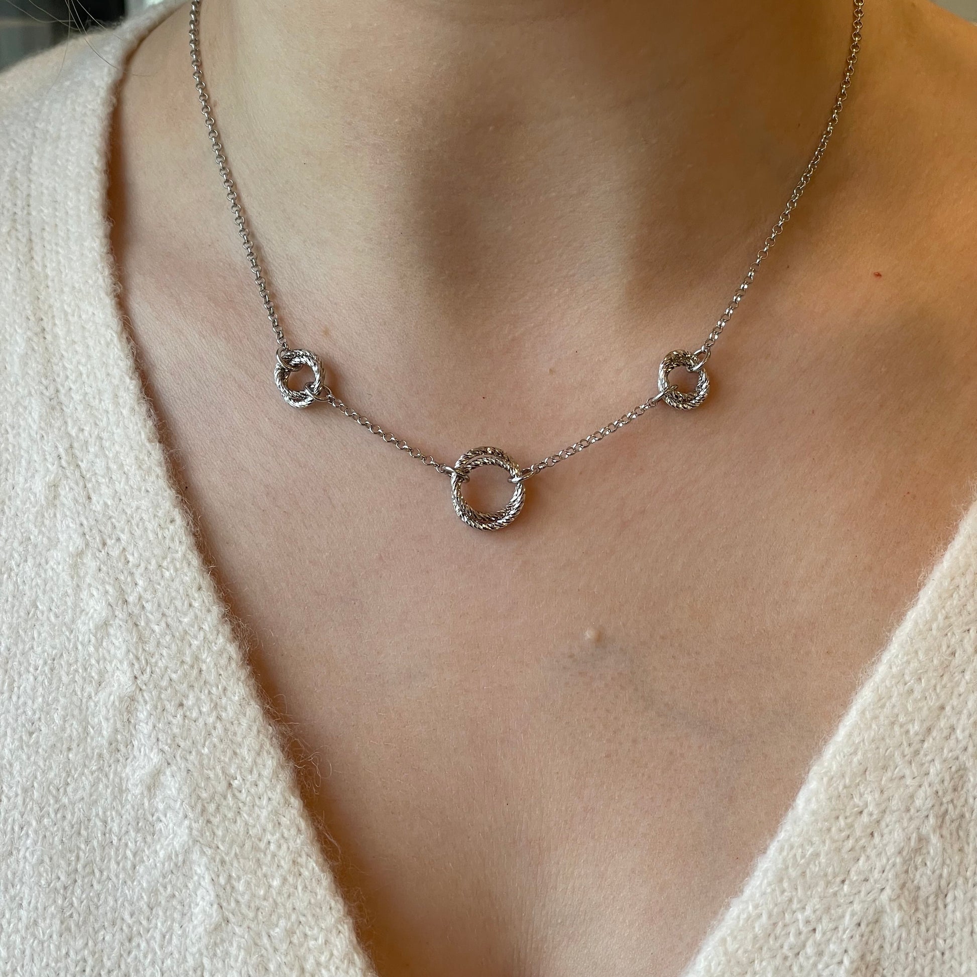 Silver Pretty Trilogy Necklace by Fraboso featuring three interconnected silver circles on a delicate chain