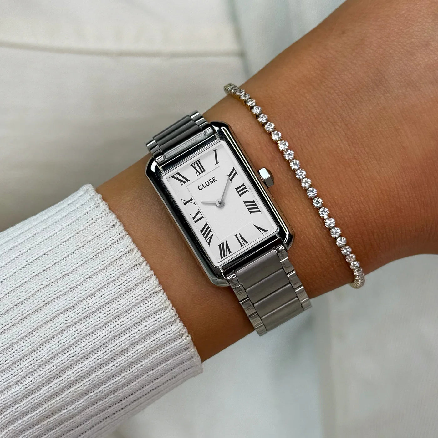 Silver CLUSE Belisenna watch with a sleek round face and minimalist design, featuring a silver metal band and clean dial.