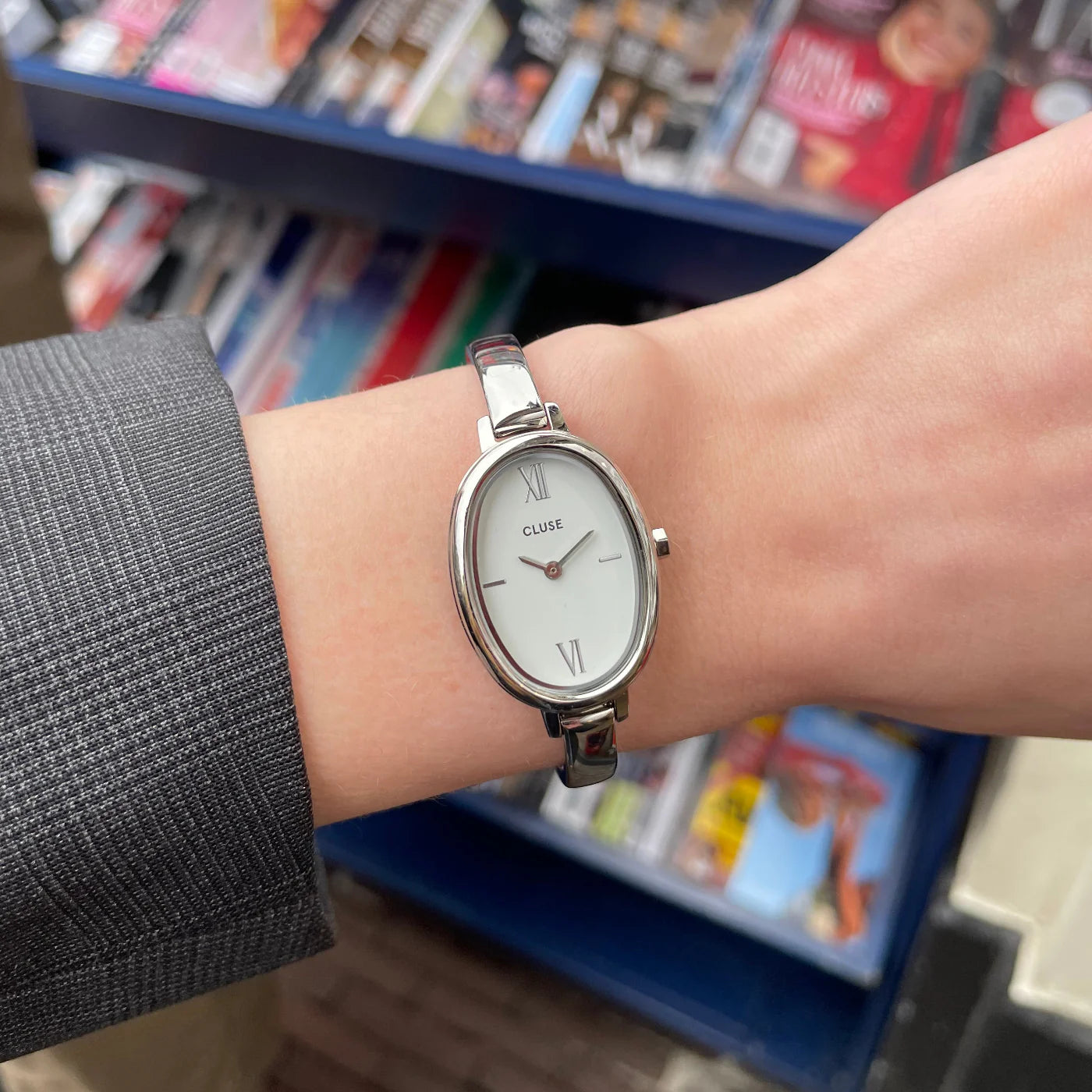 Silver CLUSE L'Ovale watch with a sleek oval face and minimalist design, featuring a silver strap and elegant dial.