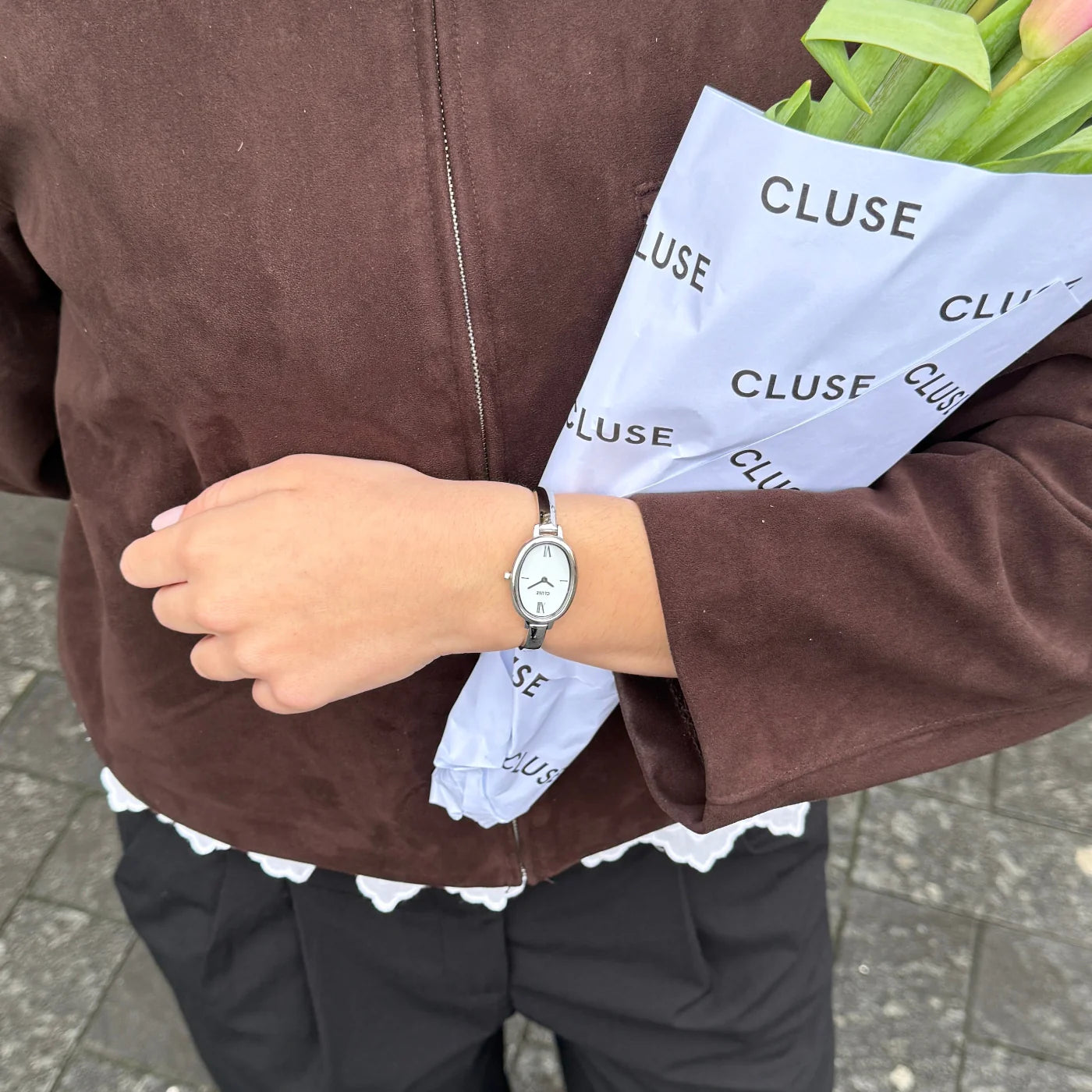 Silver CLUSE L'Ovale watch with a sleek oval face and minimalist design, featuring a silver strap and elegant details.