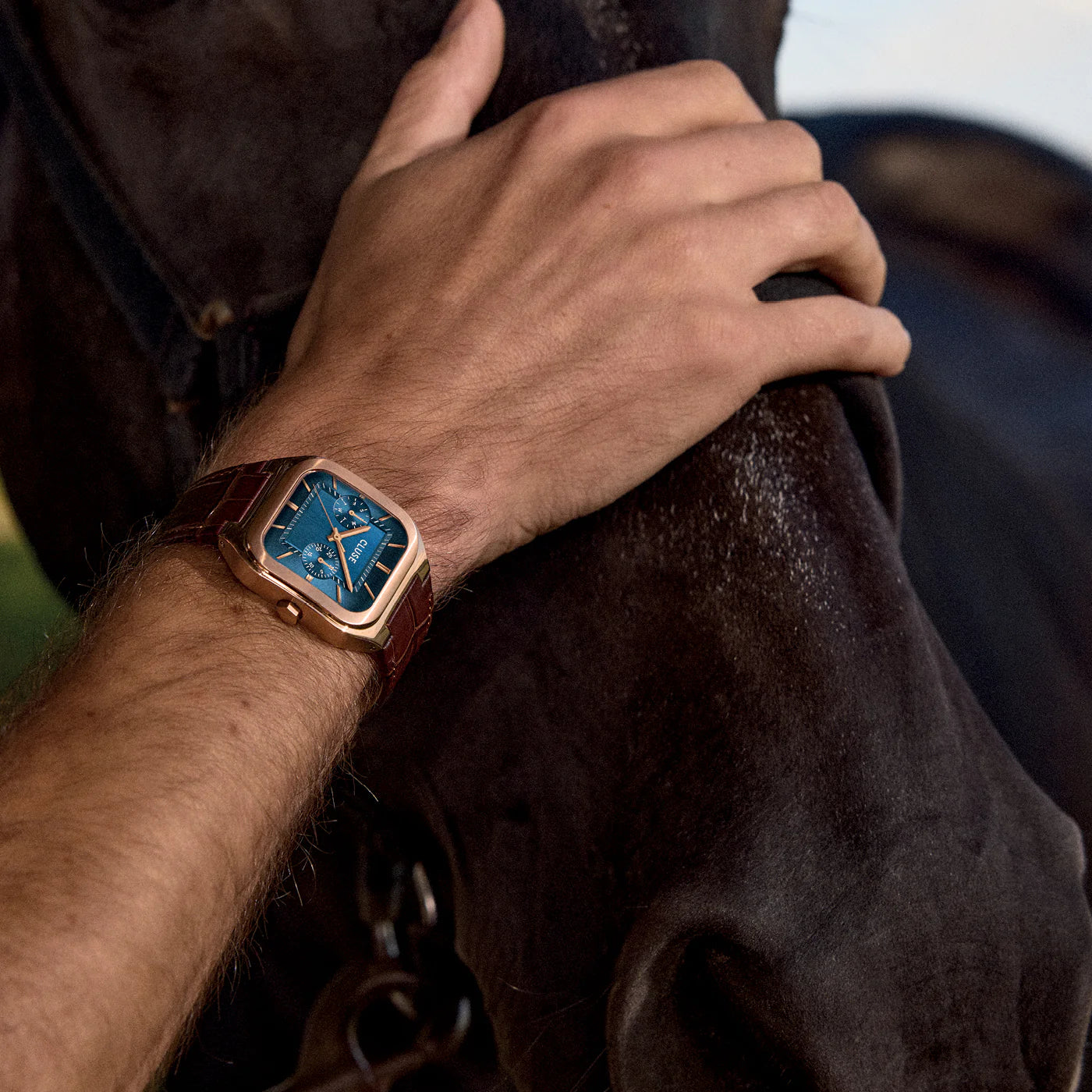 CLUSE Quadrus multifunction leather watch with rose gold and blue accents, featuring a sleek design and round dial.