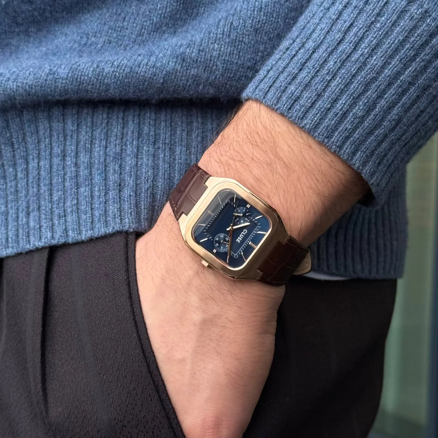 CLUSE Quadrus multifunction leather watch with rose gold and blue accents, featuring a sleek rectangular face and elegant design.