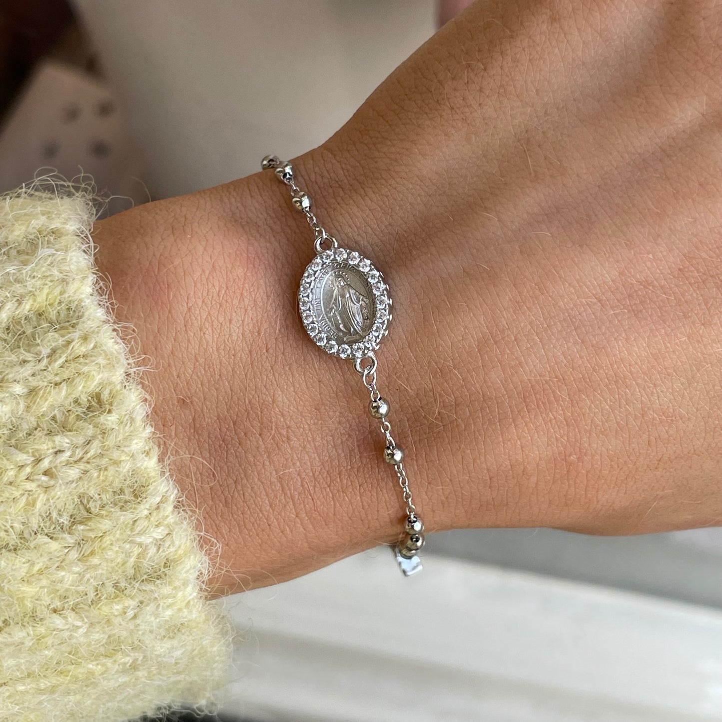Silver CZ Miraculous Rosary bracelet by Comero featuring shining cubic zirconia beads and a detailed religious charm.