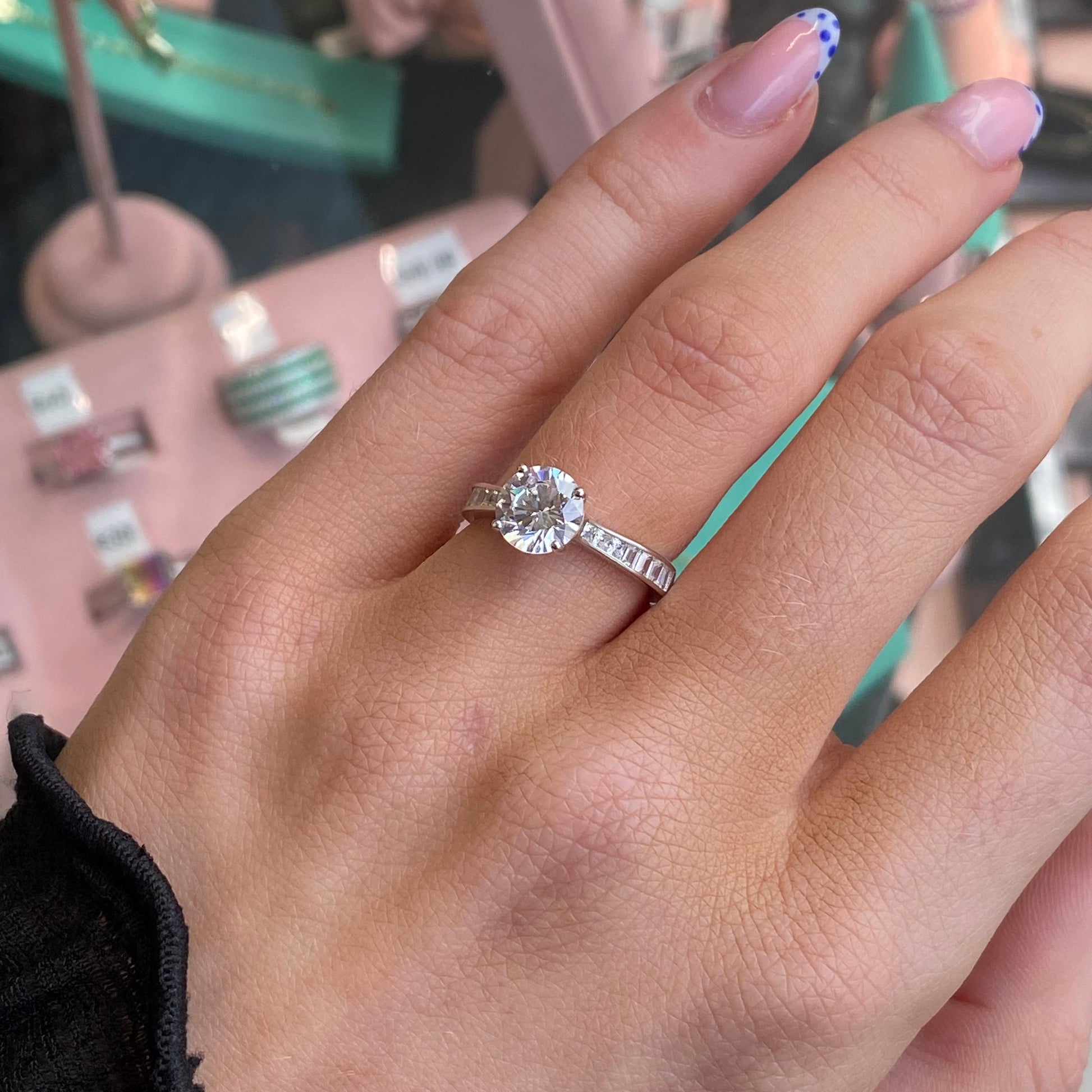 Silver CZ solitaire ring by THC featuring a prominent central cubic zirconia stone and sleek band design.