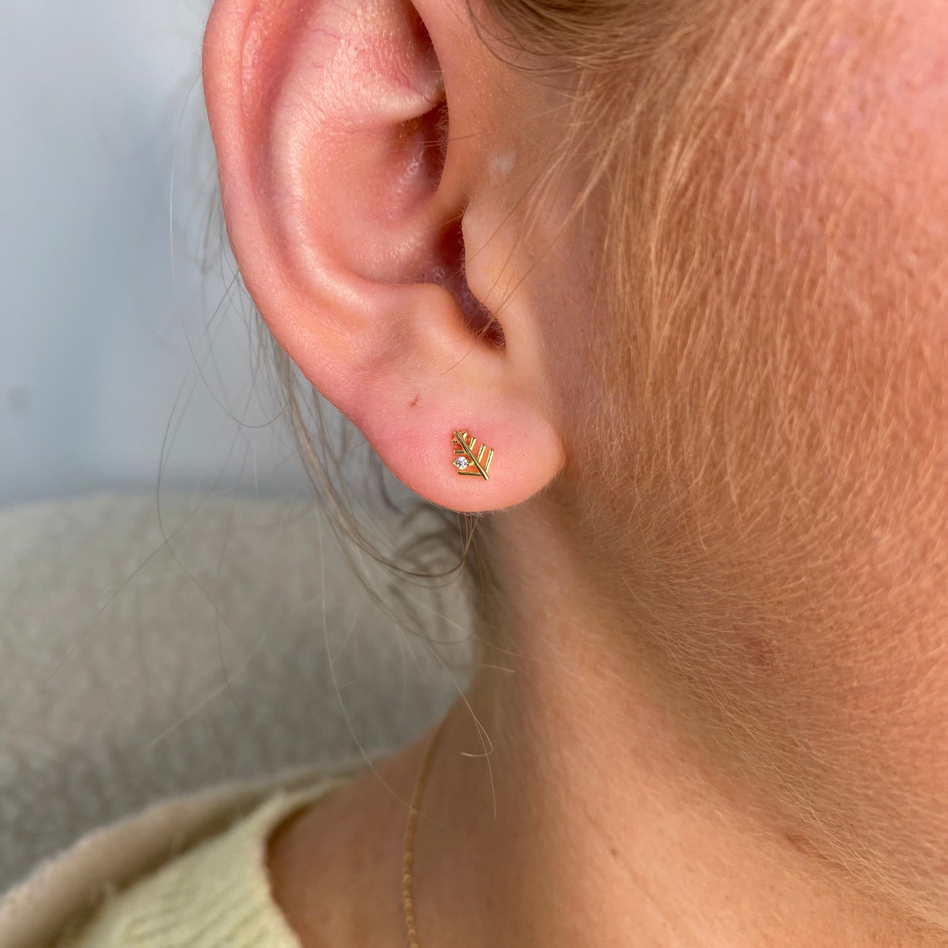 Kids' Sunshine Fern Leaf Stud Earrings by Comero featuring small, gold-tone fern leaf designs perfect for children's jewelry.