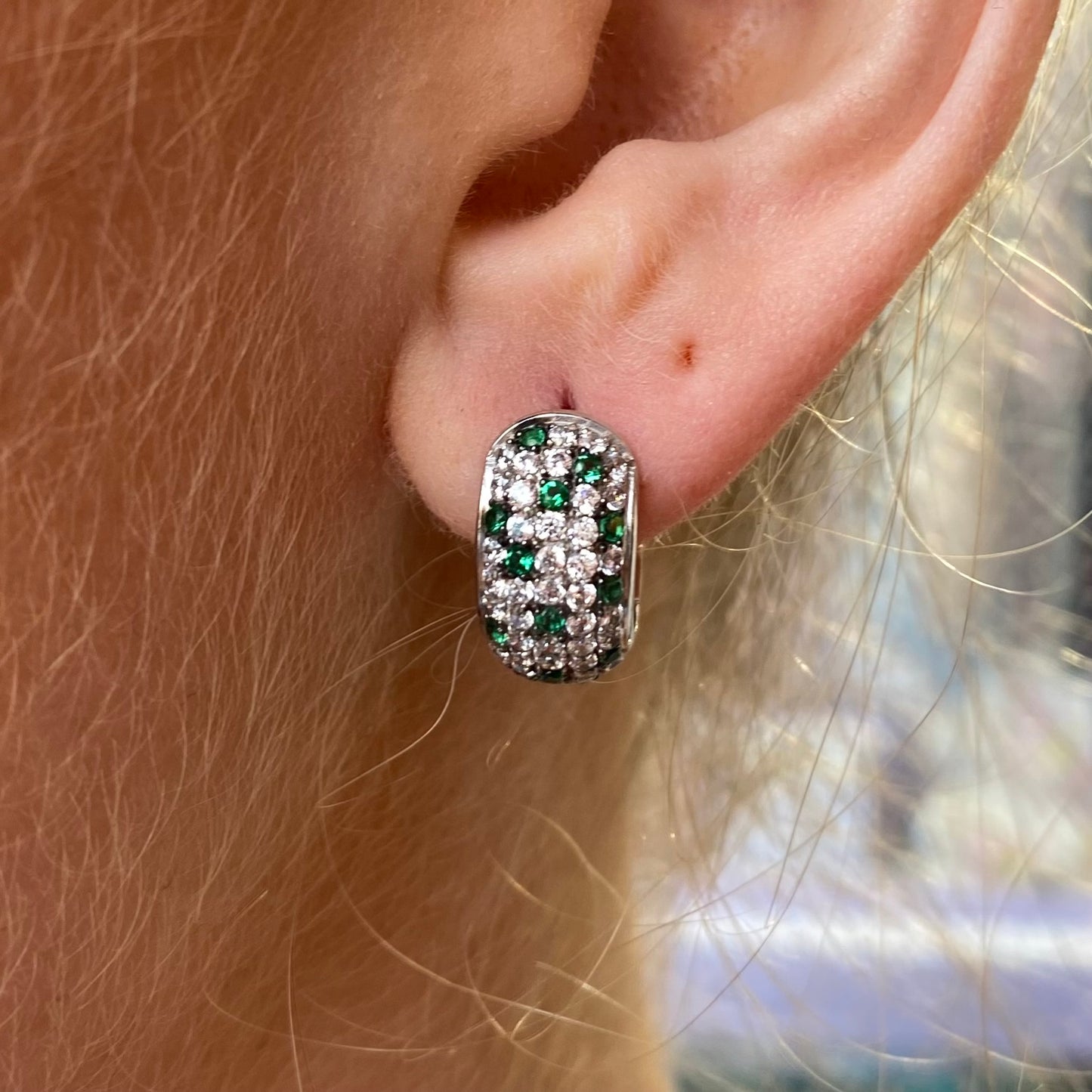 Silver green ombre huggie hoop earrings by Comero, featuring a sleek silver design with green gradient accents.
