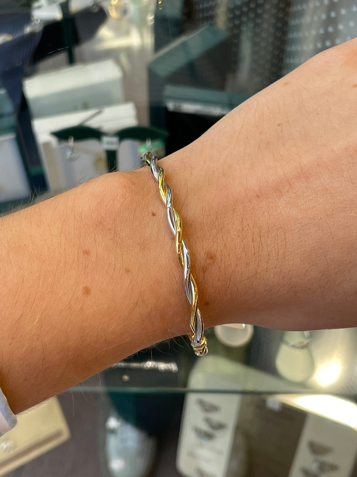 Stubbs 9ct gold two-tone twist bangle with intertwined gold and silver design on a plain background.