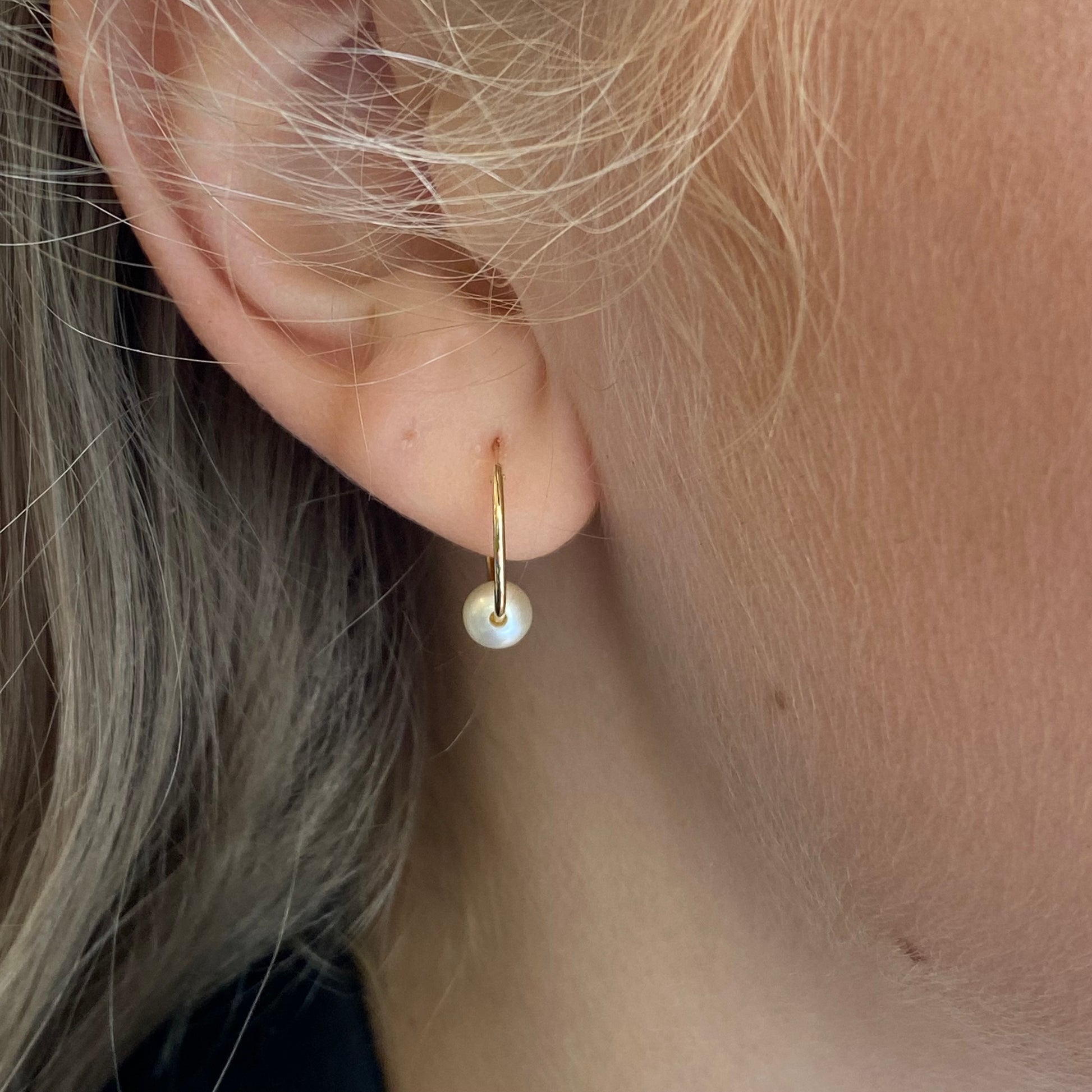 9ct gold sleeper earrings with pearl slider feature, showcasing elegant pearl accents on classic hoop-style earrings by THC.