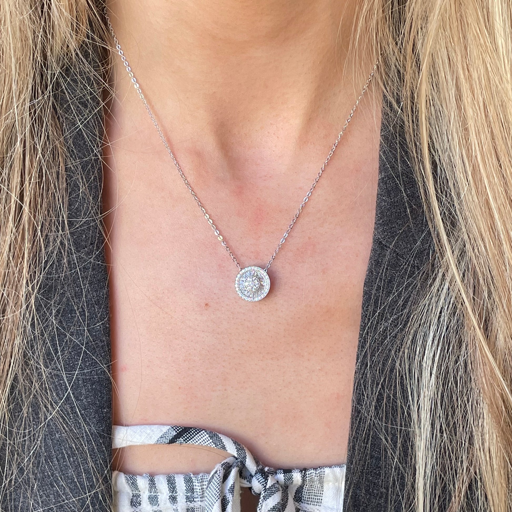 Silver CZ halo cluster necklace with baguette-cut stones by Comero, featuring a sparkling, elegant design.