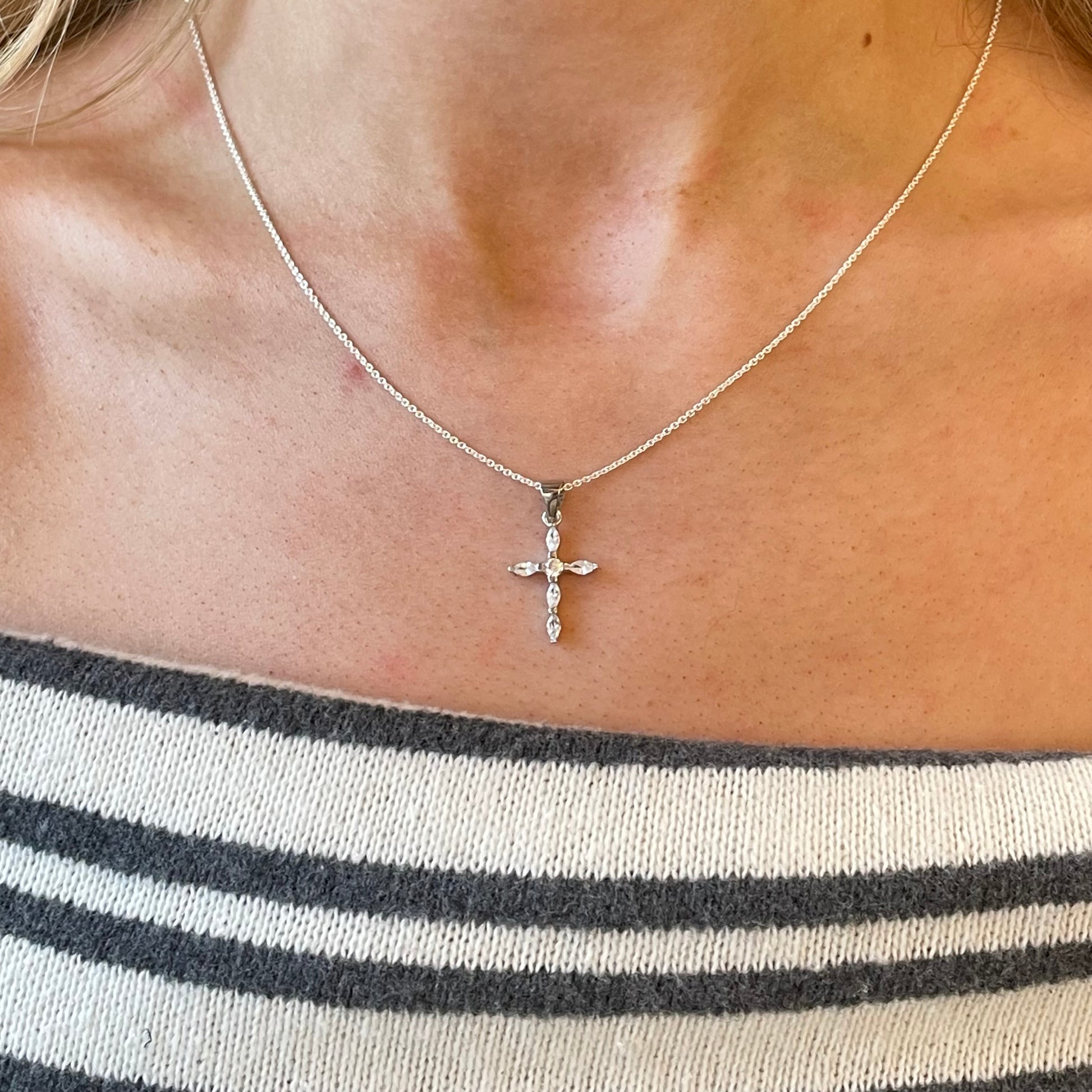 Silver CZ cross necklace on a chain, featuring sparkling cubic zirconia stones, by Comero, 18-inch length.