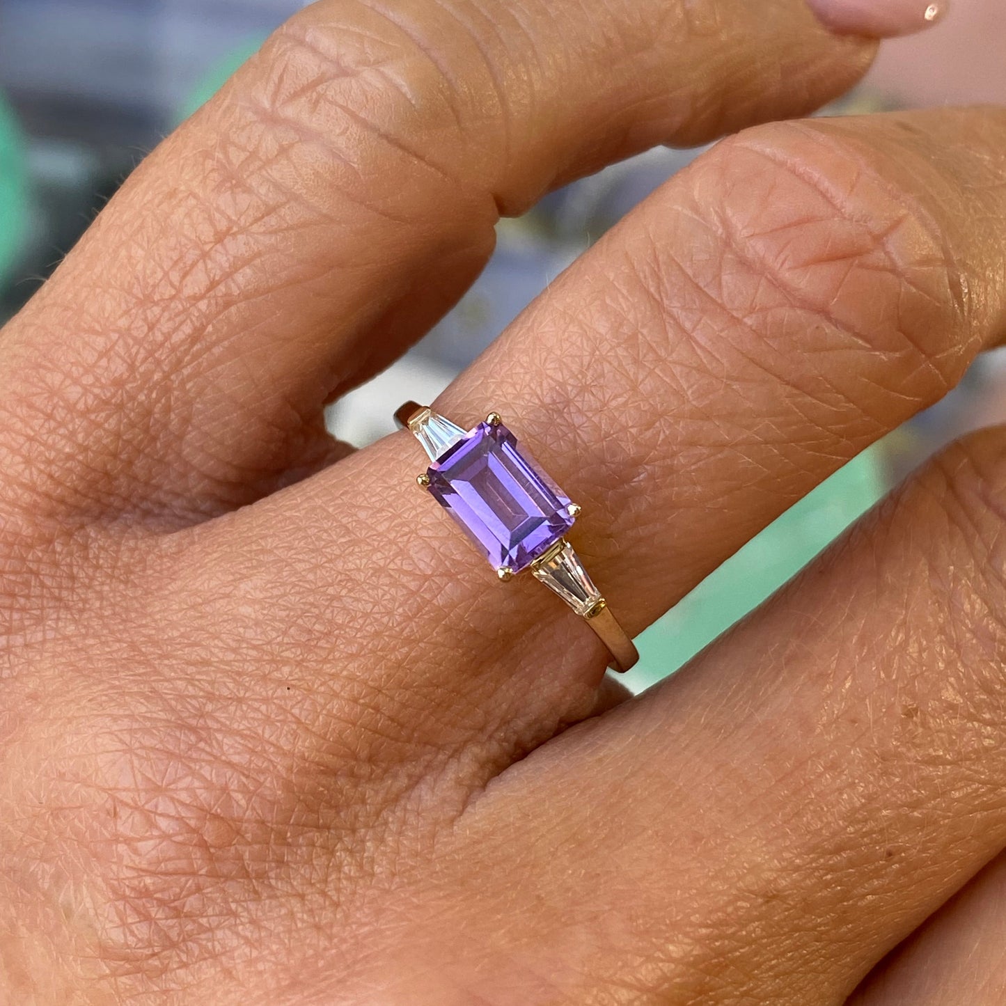 Insignia 9ct gold east-west ring with amethyst and cubic zirconia gemstones, featuring a sleek and elegant design.