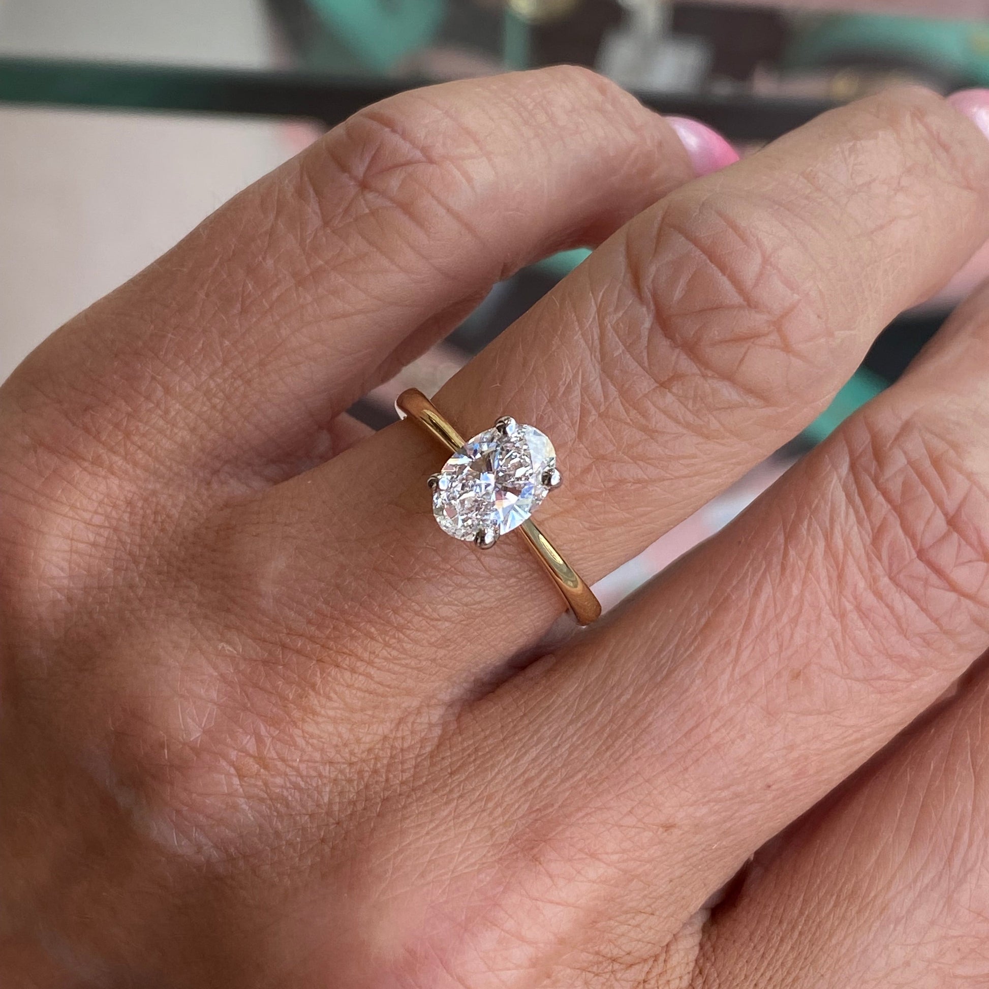 Prima 18ct gold oval solitaire engagement ring with 1.27ct certificated diamond, elegant and classic jewelry piece.