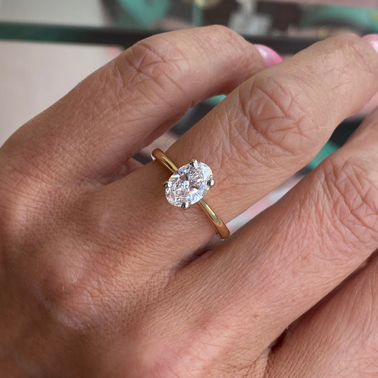Prima 18ct gold oval solitaire engagement ring with 1.27ct certificated diamond, elegant and classic jewelry piece.
