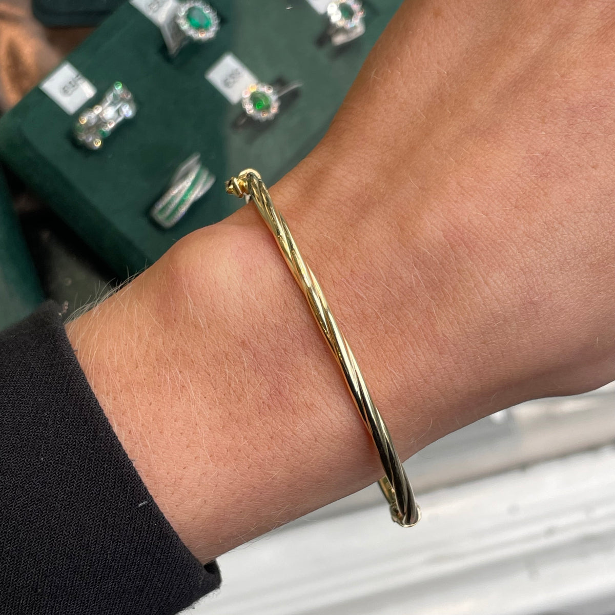 NJO Sunshine Twist Bangle featuring a sleek, twisted design with a shiny gold finish, stylish jewelry accessory.