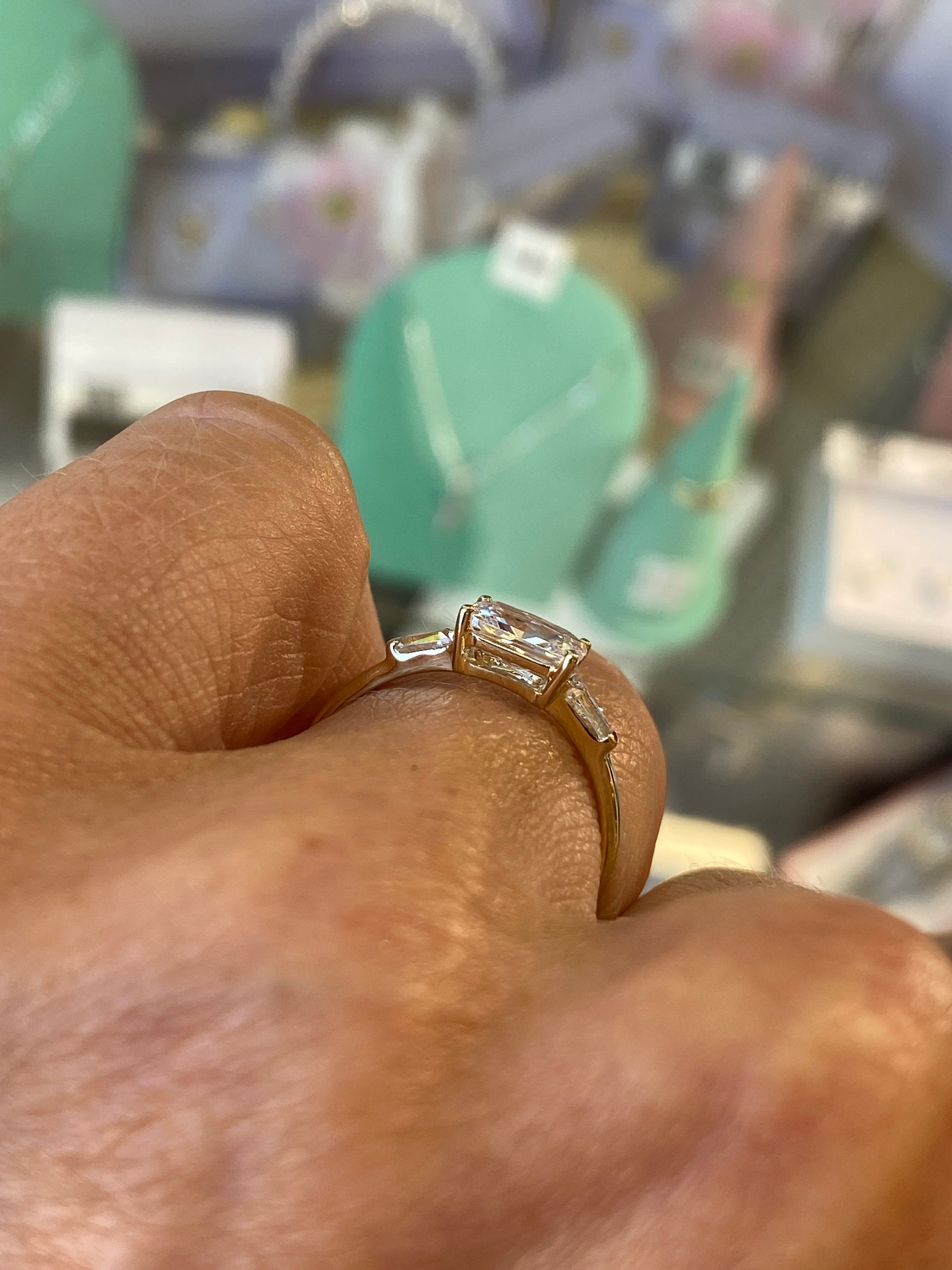 9ct gold east-west ring with cubic zirconia by Insignia, showcasing a sleek design and sparkling stones on a white background.
