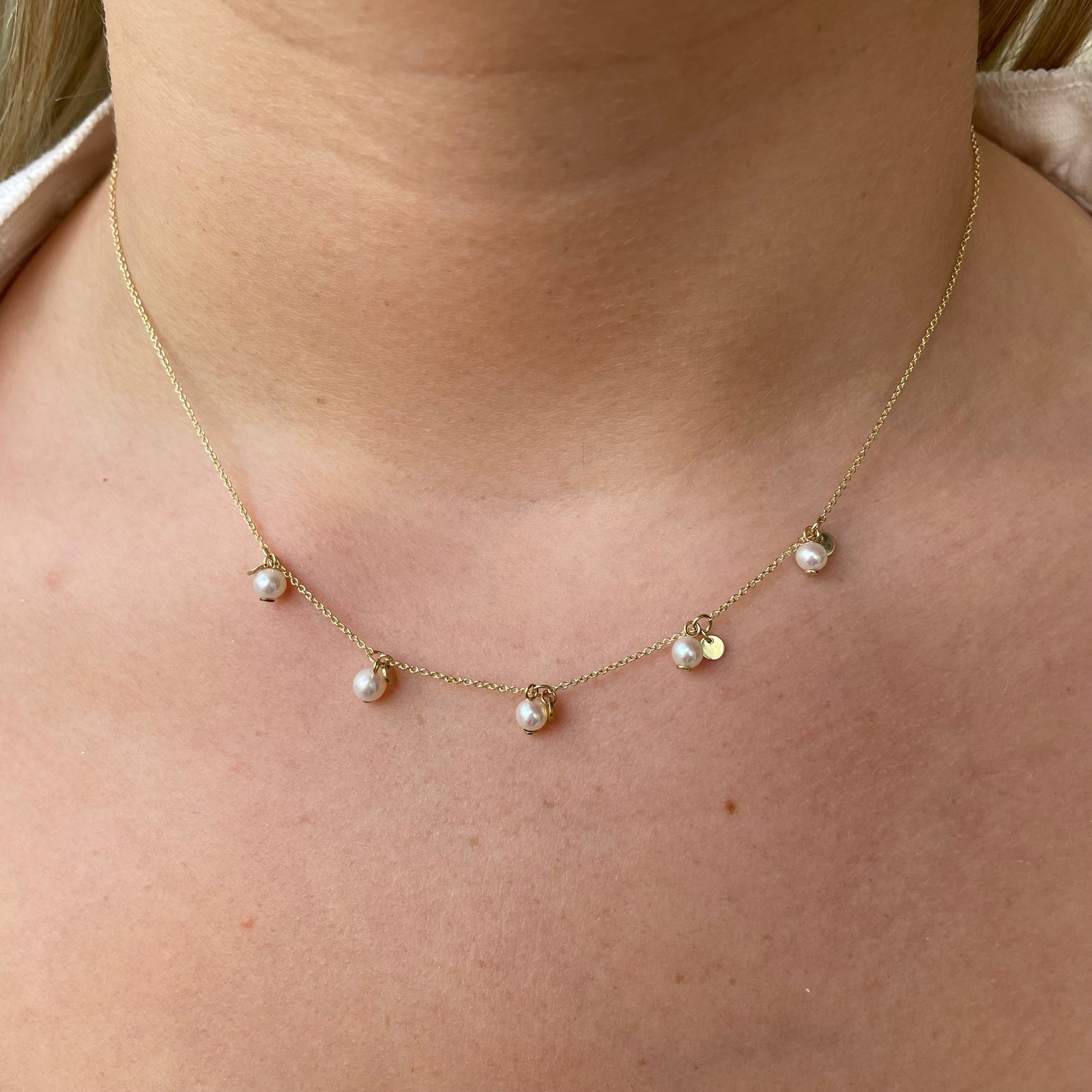 9ct gold pearl fringe necklace featuring a delicate chain and hanging pearl accents by G Molins & Company Limited.