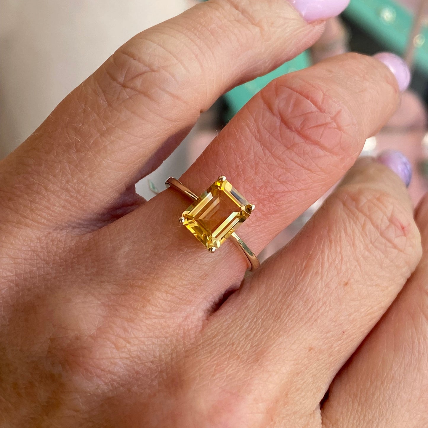 Insignia 9ct gold emerald cut citrine ring showcasing a vibrant yellow gemstone set in a sleek gold band.