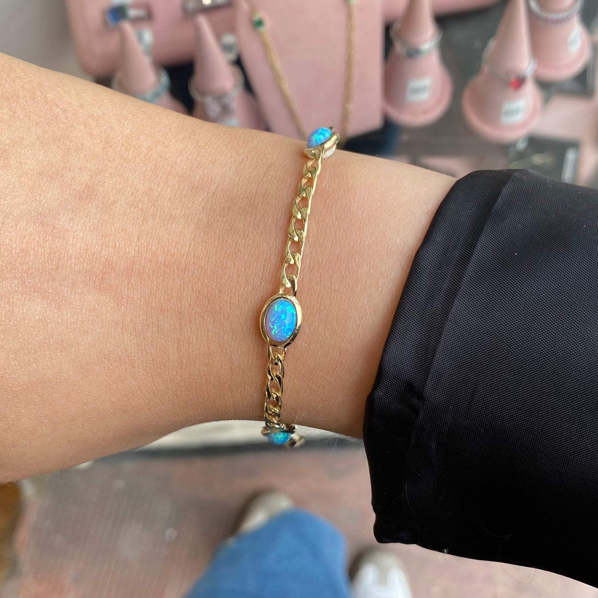 Reversible 9ct gold bracelet with blue and white Opalique stones by PJD, showcasing intricate design and vibrant colors.