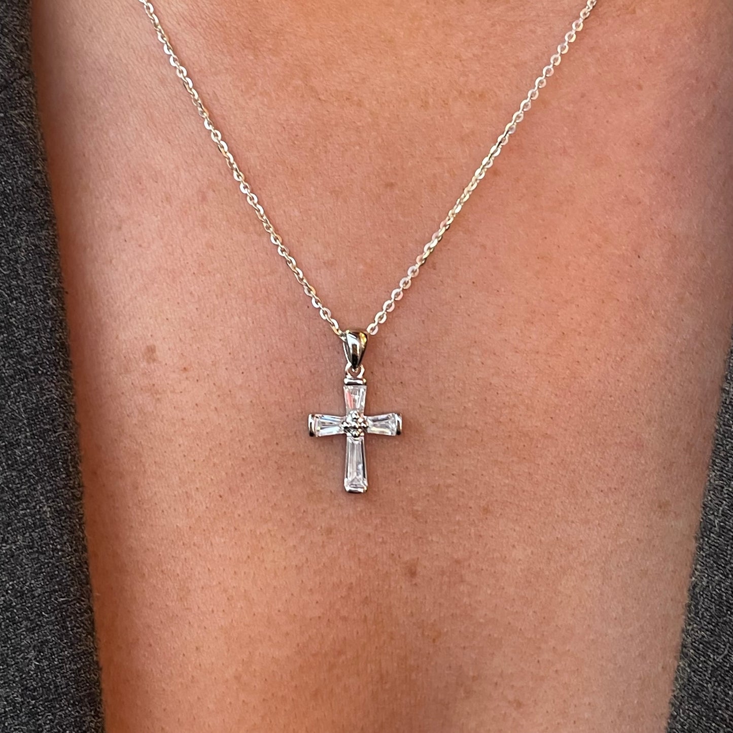 Silver CZ cross necklace on 18-inch chain by Comero, featuring a detailed cross pendant with sparkling cubic zirconia stones.
